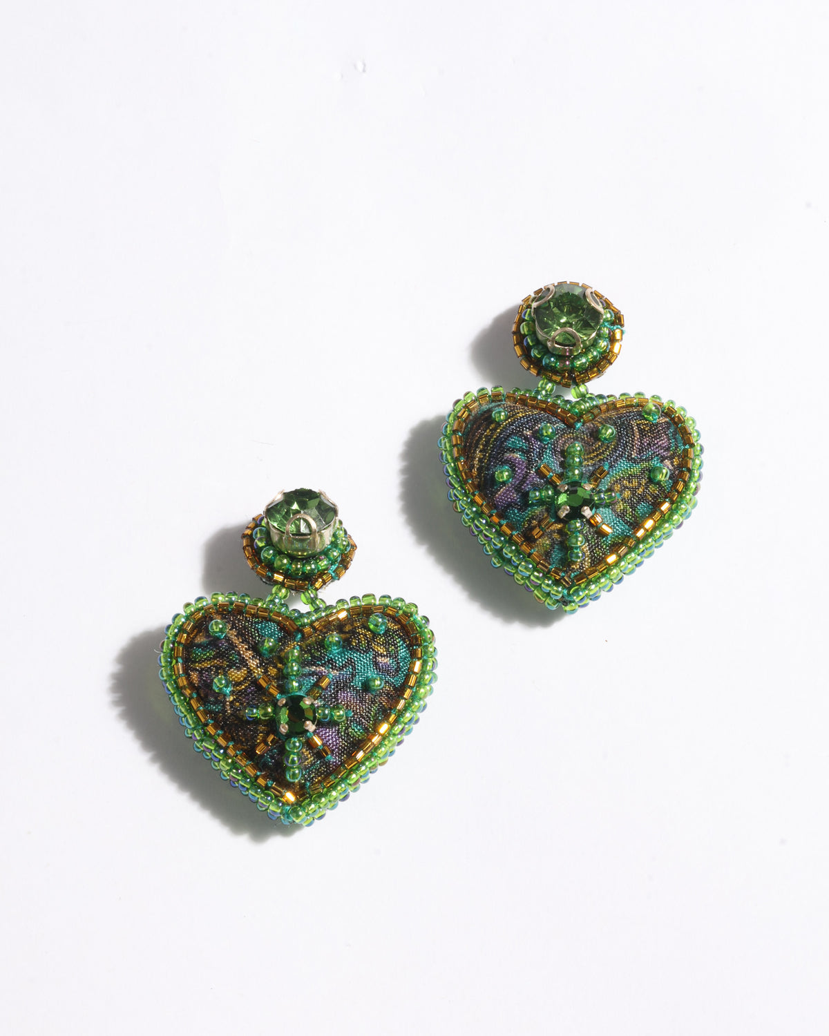Heart drop earrings with green abstract fabric and green bead embellishments, shown flat on white background