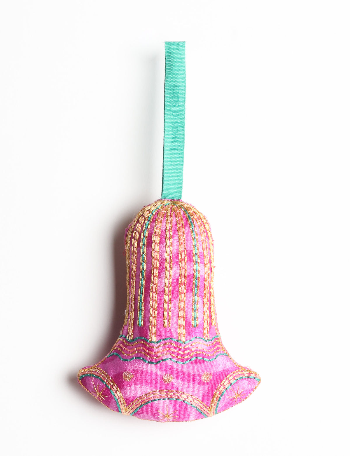 Red fabric bell ornament with gold and teal stitched details and a teal hanging loop with faint text visible