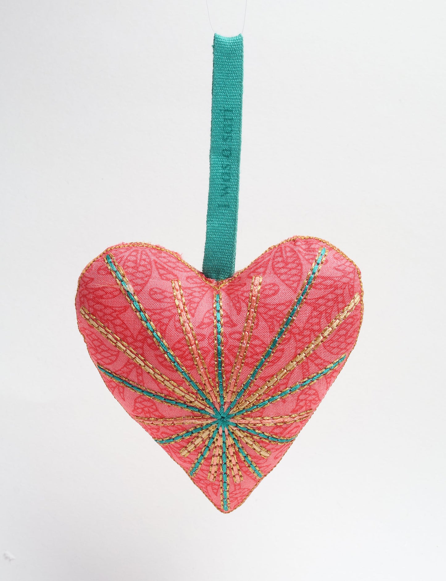 Timeless Heart ornament made from upcycled clothing and recycled fabric, filled with organic cotton and hand-finished with vibrant silk and metallic thread. An eco-friendly, carbon neutral fashion piece that supports green fashion and fair trade apparel.