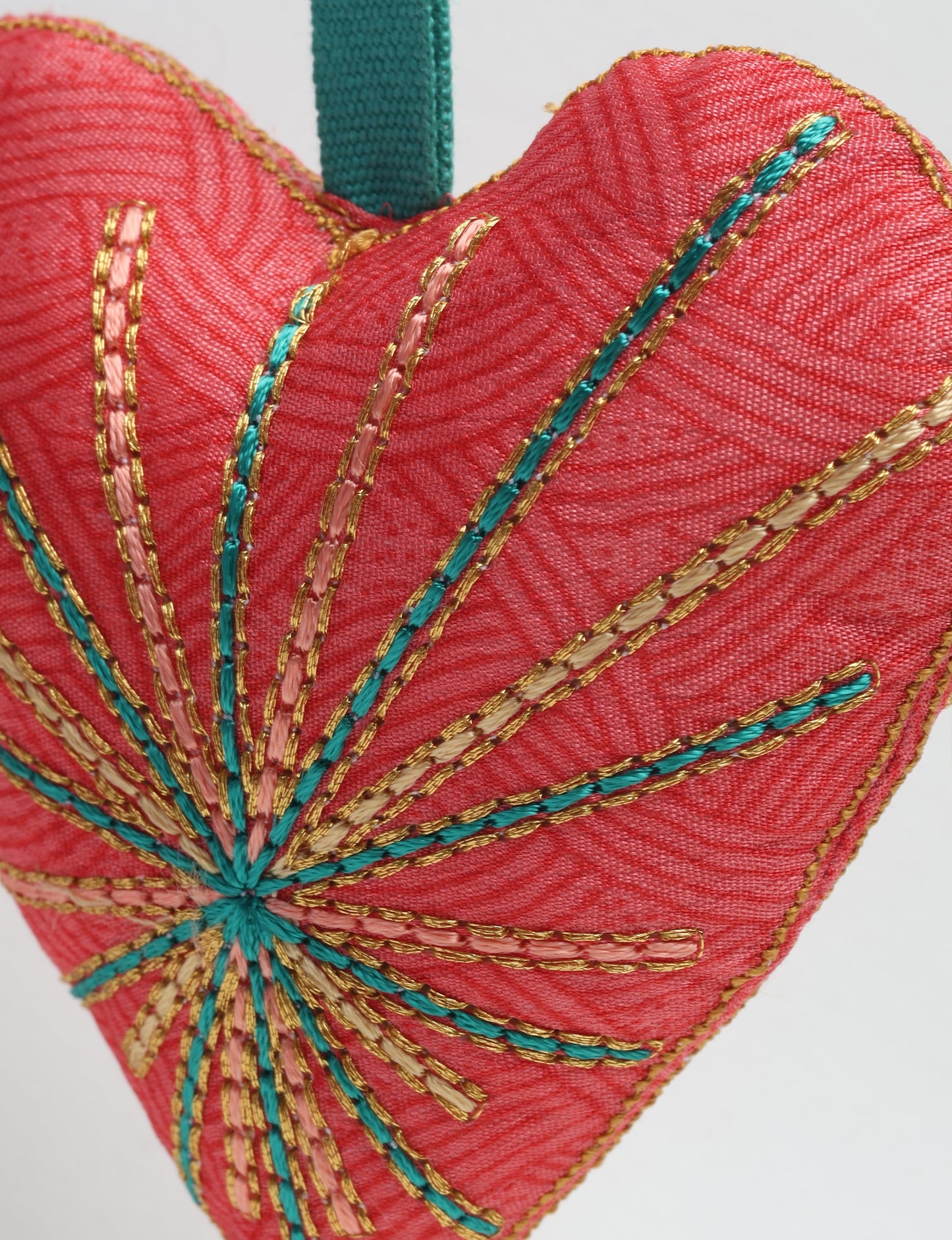 Timeless Heart ornament made from upcycled clothing and recycled fabric, filled with organic cotton and hand-finished with vibrant silk and metallic thread. An eco-friendly, carbon neutral fashion piece that supports green fashion and fair trade apparel.