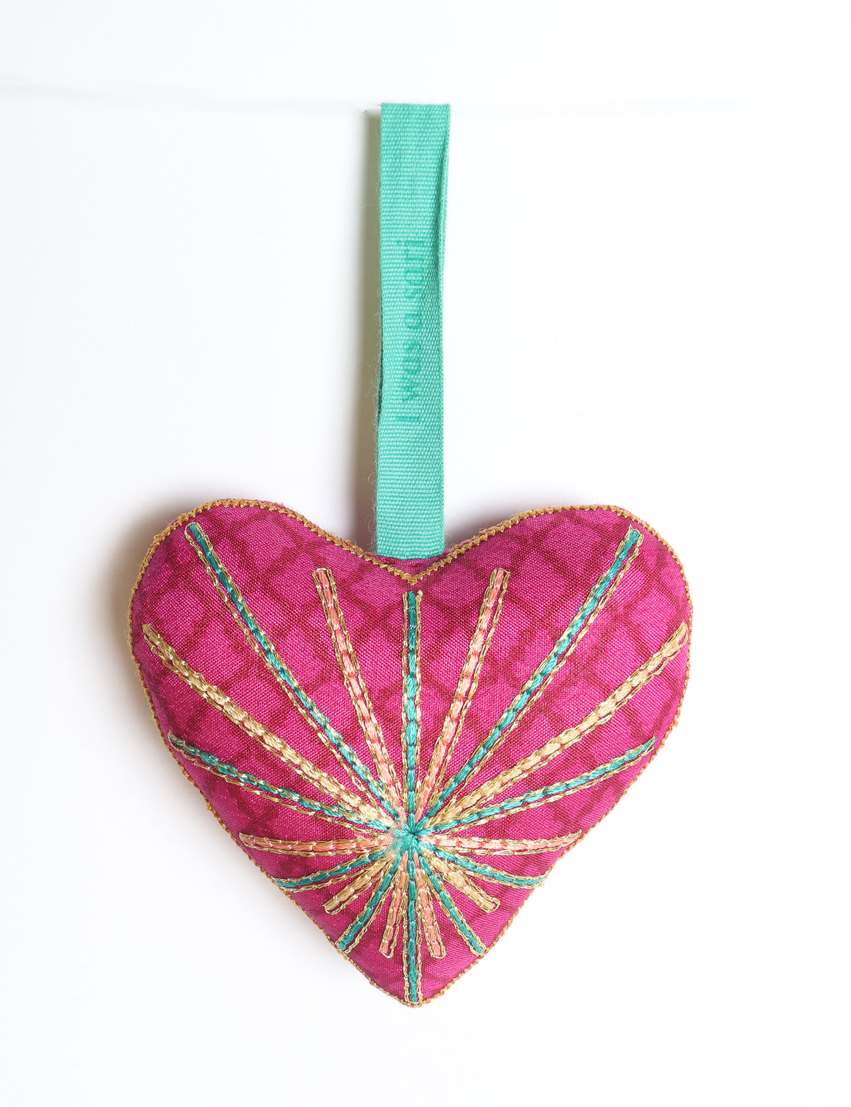 Timeless Heart ornament made from upcycled clothing and recycled fabric, filled with organic cotton and hand-finished with vibrant silk and metallic thread. An eco-friendly, carbon neutral fashion piece that supports green fashion and fair trade apparel.
