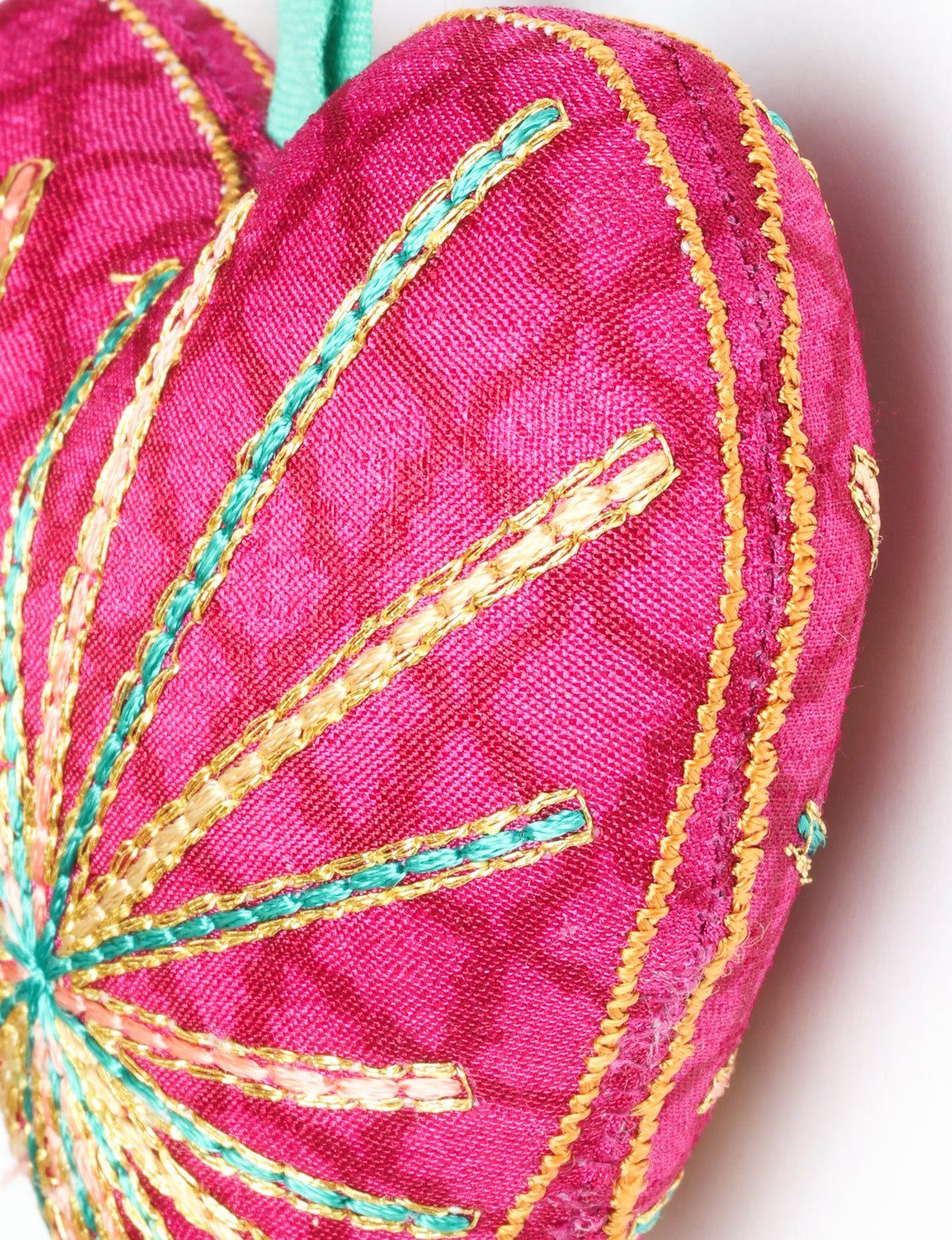 Timeless Heart ornament made from upcycled clothing and recycled fabric, filled with organic cotton and hand-finished with vibrant silk and metallic thread. An eco-friendly, carbon neutral fashion piece that supports green fashion and fair trade apparel.