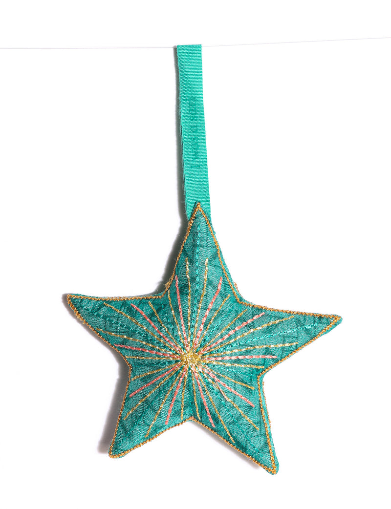 Timeless star ornament made from recycled sari fabric, featuring silk and metallic embroidery, crafted as part of green fashion, recycled clothing design, environmentally friendly clothing practices, and repurposed clothing traditions.