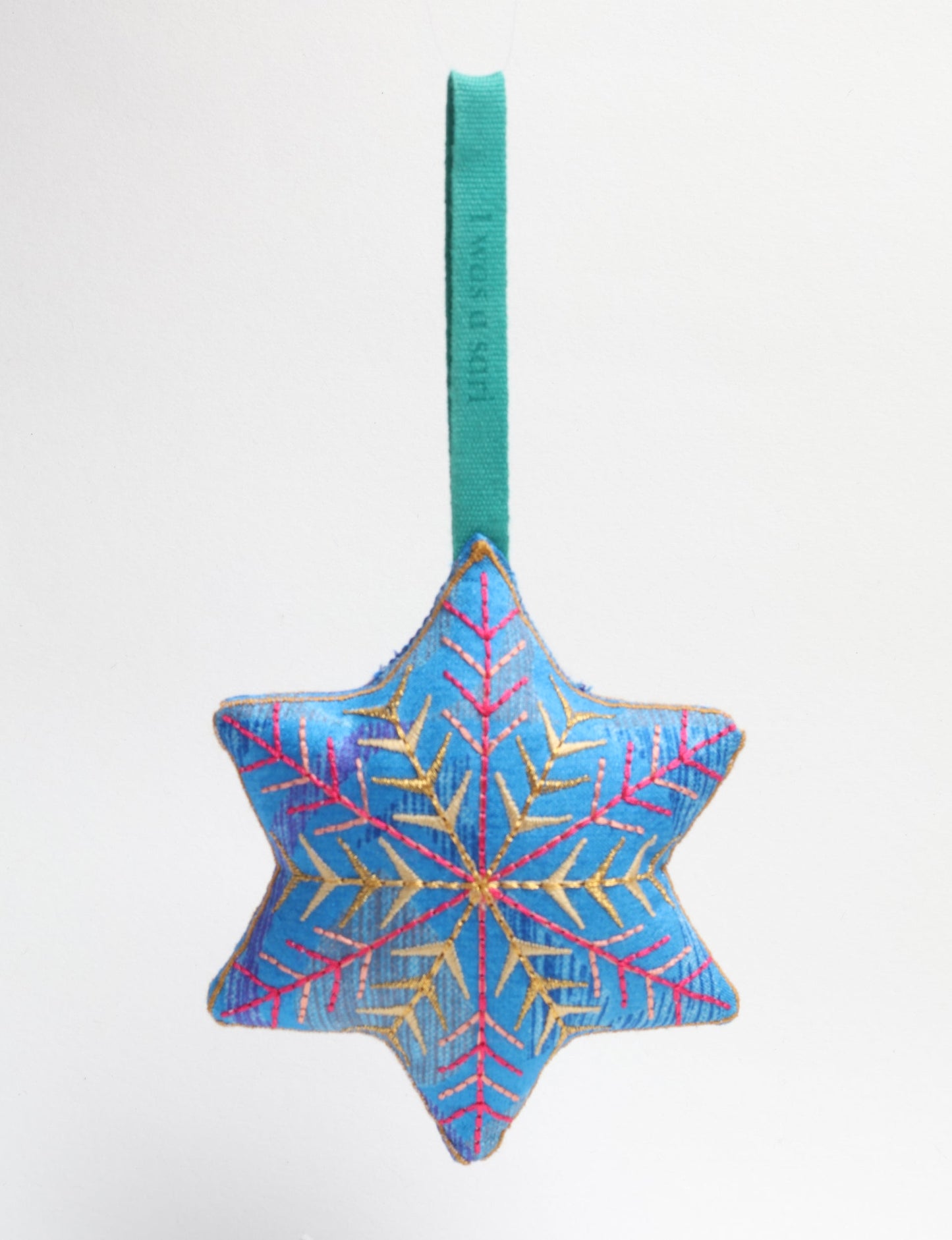 Timeless snowflake ornament made from preloved sari fabric with metallic embroidery, promoting green fashion, fair trade fashion, recycled material clothing, repurposed clothing, sustainable women's clothing, and circular fashion for a conscious lifestyle.
