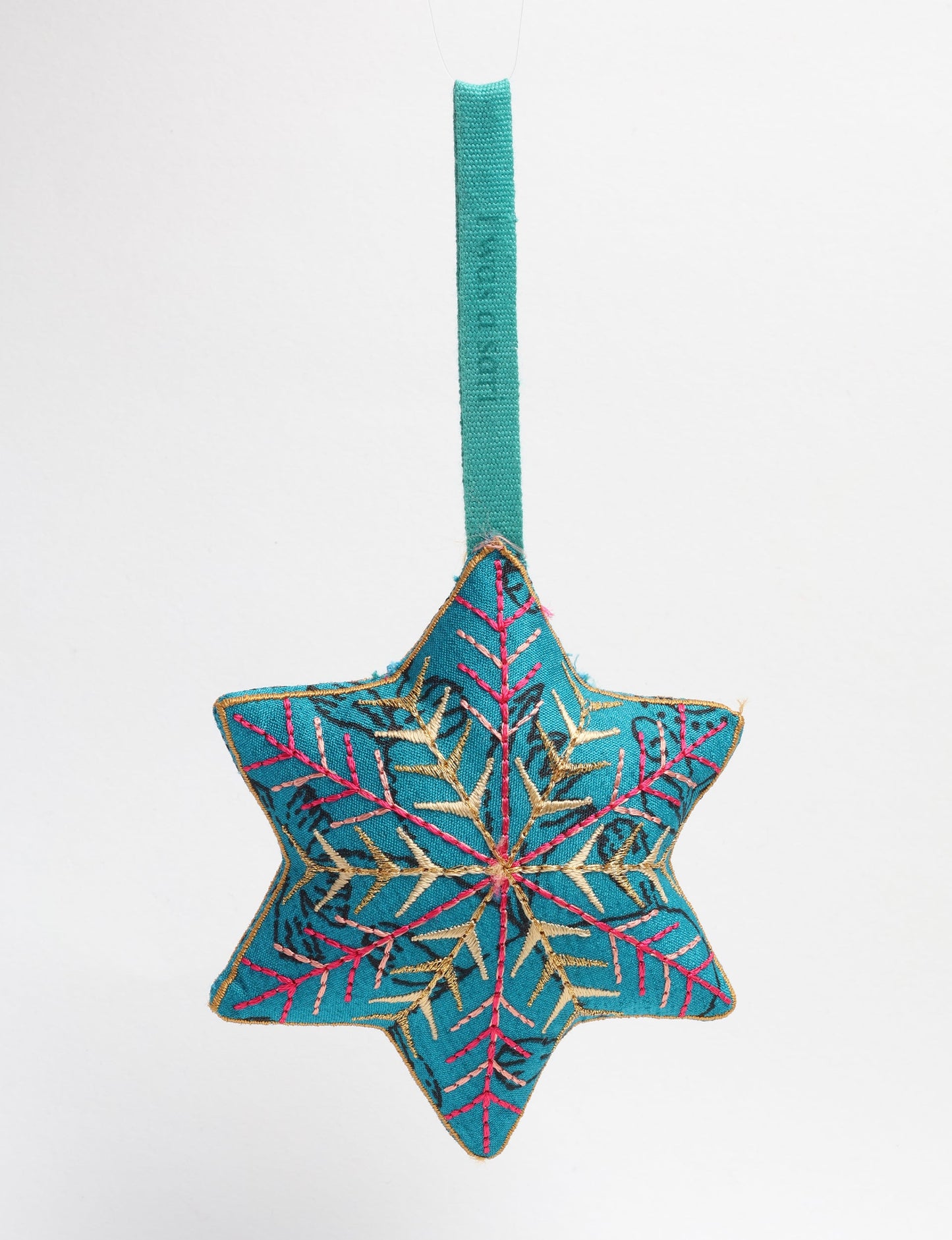 Timeless snowflake ornament made from preloved sari fabric with metallic embroidery, promoting green fashion, fair trade fashion, recycled material clothing, repurposed clothing, sustainable women's clothing, and circular fashion for a conscious lifestyle.