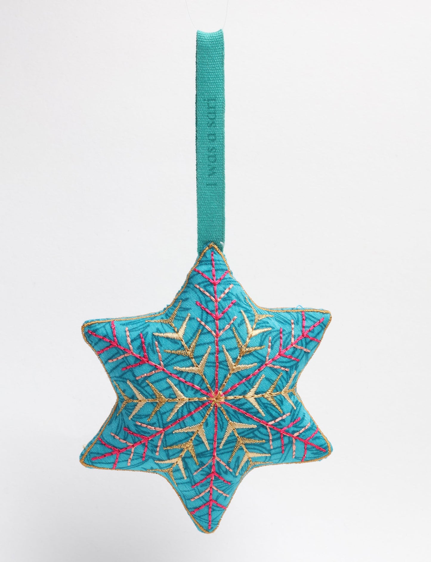 Timeless snowflake ornament made from preloved sari fabric with metallic embroidery, promoting green fashion, fair trade fashion, recycled material clothing, repurposed clothing, sustainable women's clothing, and circular fashion for a conscious lifestyle.