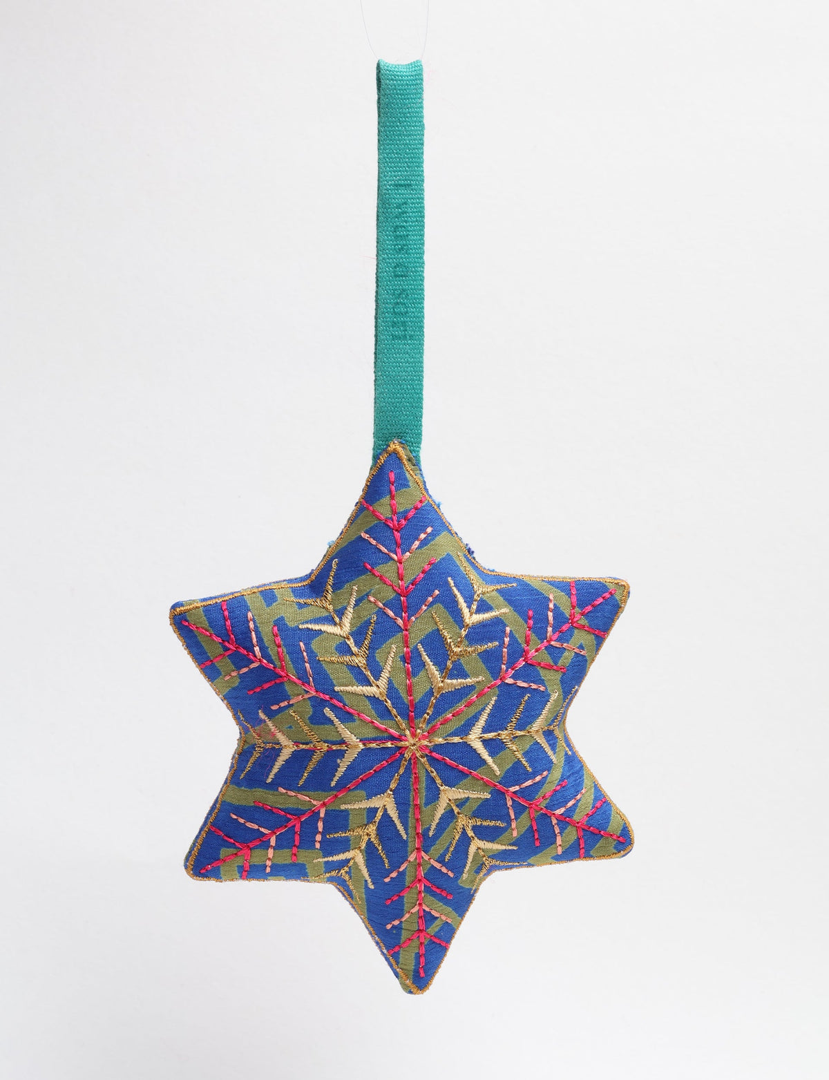 Blue fabric star-shaped ornament with gold and pink embroidered snowflake design and green hanging loop