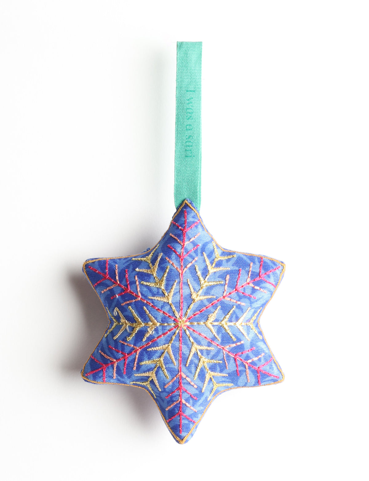 Blue fabric star-shaped ornament with gold and pink embroidered snowflake design and green hanging loop