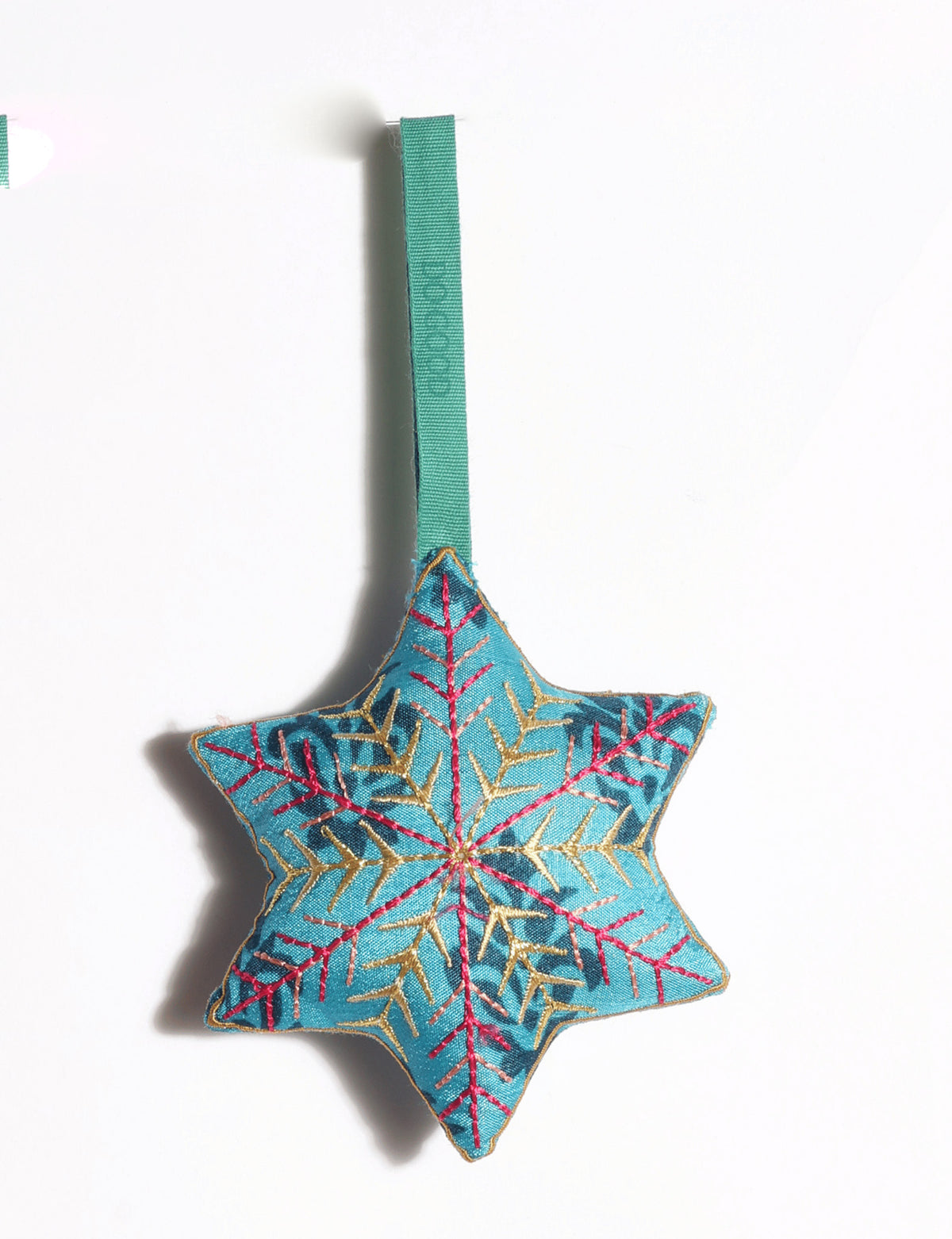 Handcrafted snowflake Christmas ornament made from preloved saris with silk and metallic gold thread embroidery