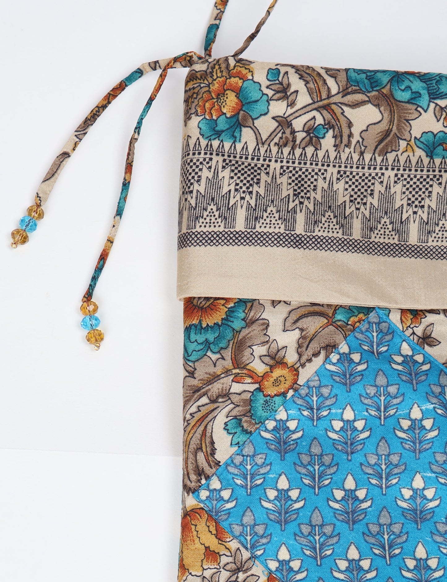 Timeless Christmas stocking made from recycled sari fabric, featuring colorful patchwork, tassel details, and crafted with care in line with circular fashion, upcycling fashion, carbon neutral clothing, and environmentally friendly clothing ideals — a beautiful piece of repurposed clothing and eco clothing for sustainable women’s fashion.