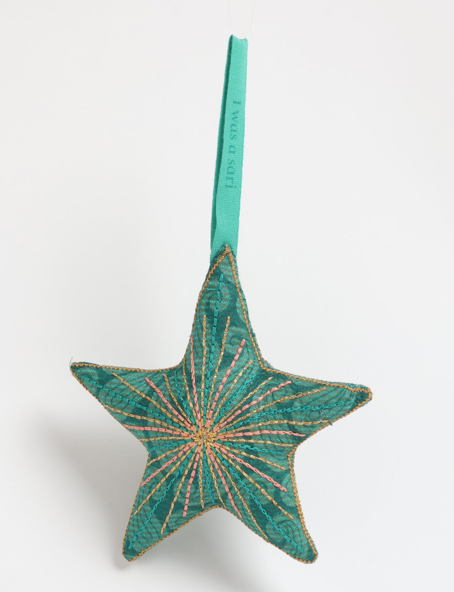 Timeless star ornament made from recycled sari fabric, featuring silk and metallic embroidery, crafted as part of green fashion, recycled clothing design, environmentally friendly clothing practices, and repurposed clothing traditions.
