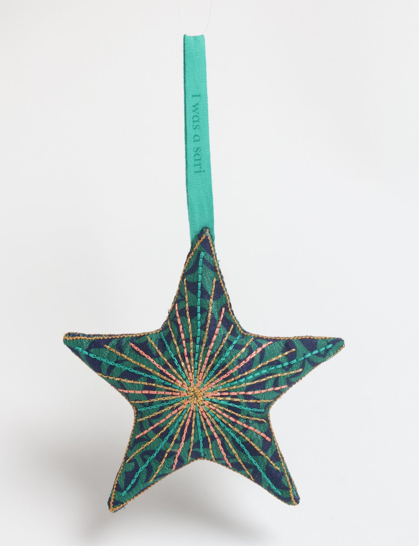 Timeless star ornament made from recycled sari fabric, featuring silk and metallic embroidery, crafted as part of green fashion, recycled clothing design, environmentally friendly clothing practices, and repurposed clothing traditions.