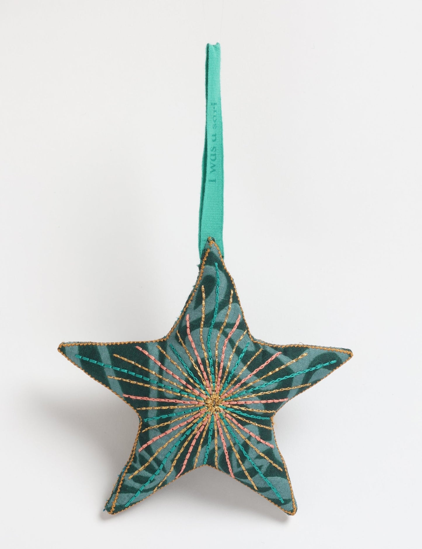 Timeless star ornament made from recycled sari fabric, featuring silk and metallic embroidery, crafted as part of green fashion, recycled clothing design, environmentally friendly clothing practices, and repurposed clothing traditions.