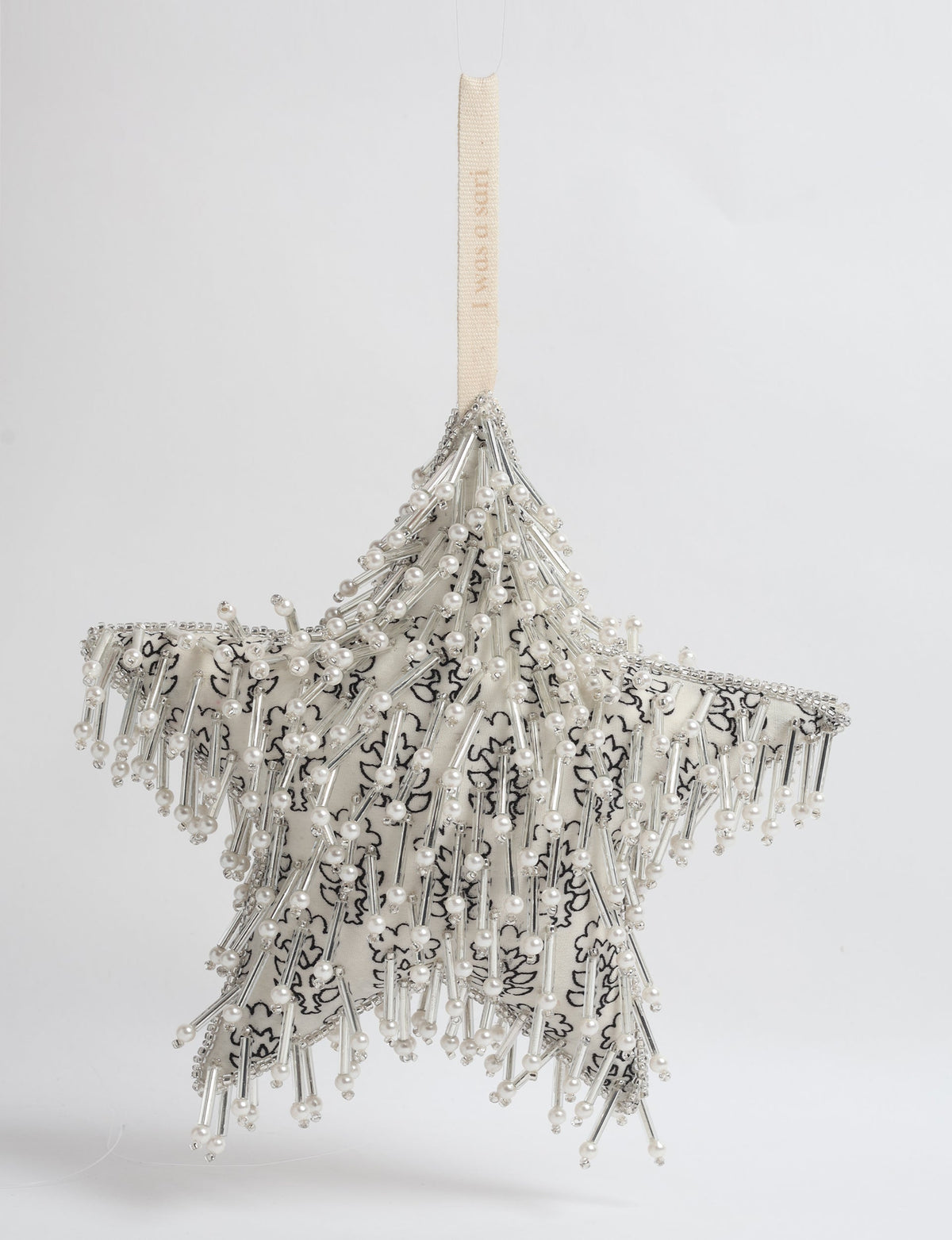 Silver star ornament with white floral fabric, decorated with pearl and silver bead embellishments, hanging by a cream loop