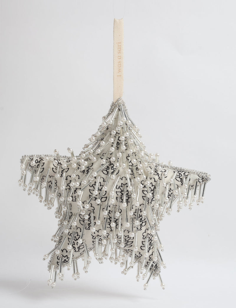 Silver star ornament with white floral fabric, decorated with pearl and silver bead embellishments, hanging by a cream loop