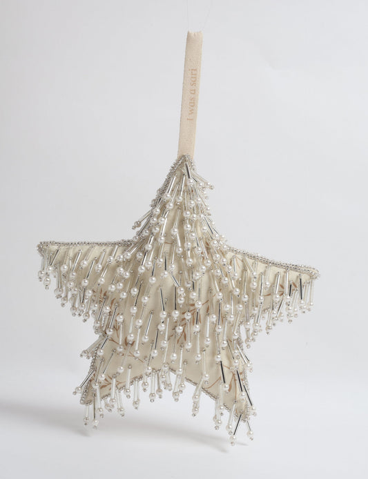 Upcycled silver star Christmas ornament made from recycled sari fabric, hand embroidered with sequins, pearls, and glass beads — a fair trade, slow fashion, and zero waste clothing accessory.