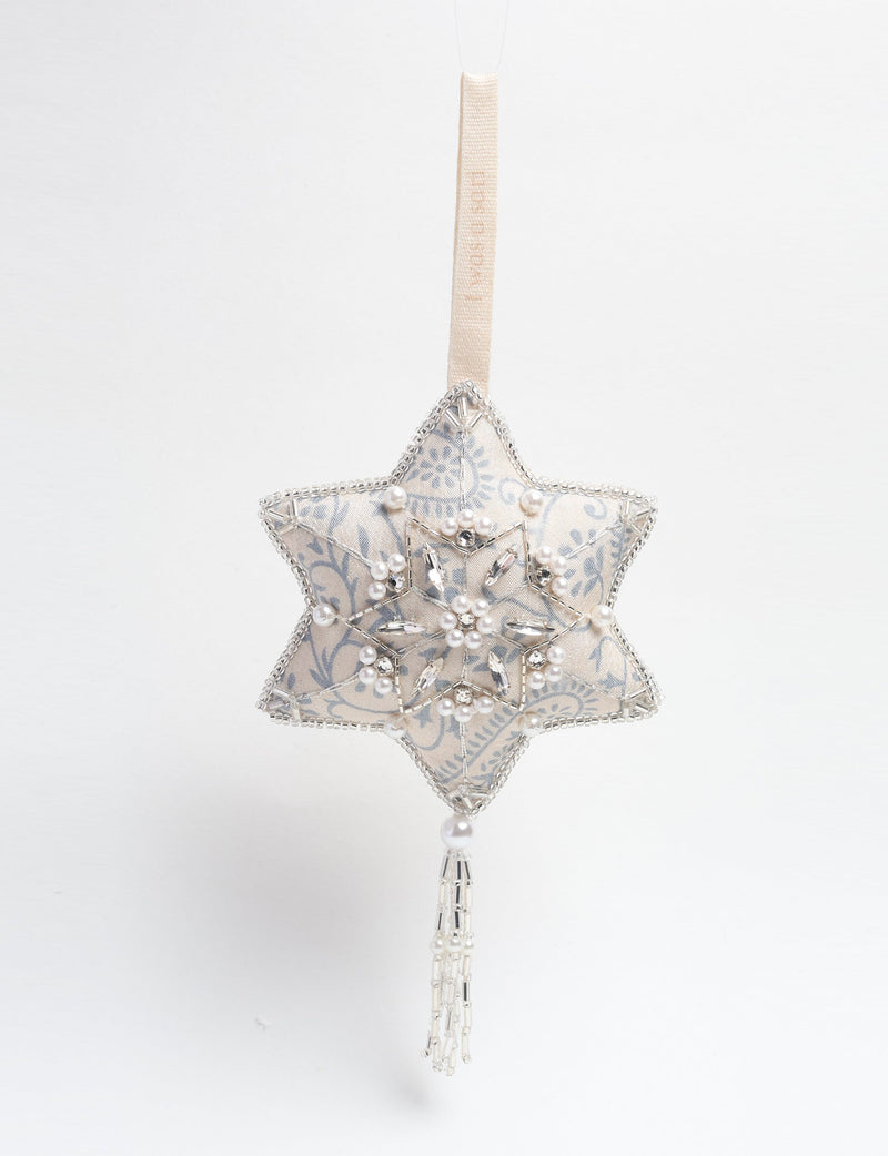 Silver fabric star ornament with blue floral pattern, pearl and crystal bead embellishments, and hanging tassel detail