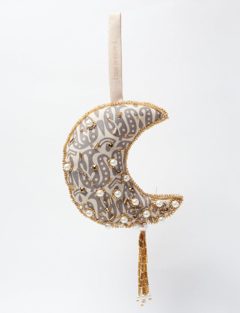 Crescent moon ornament with gray paisley fabric, gold bead trim, pearl and gold bead embellishments, and hanging tassel