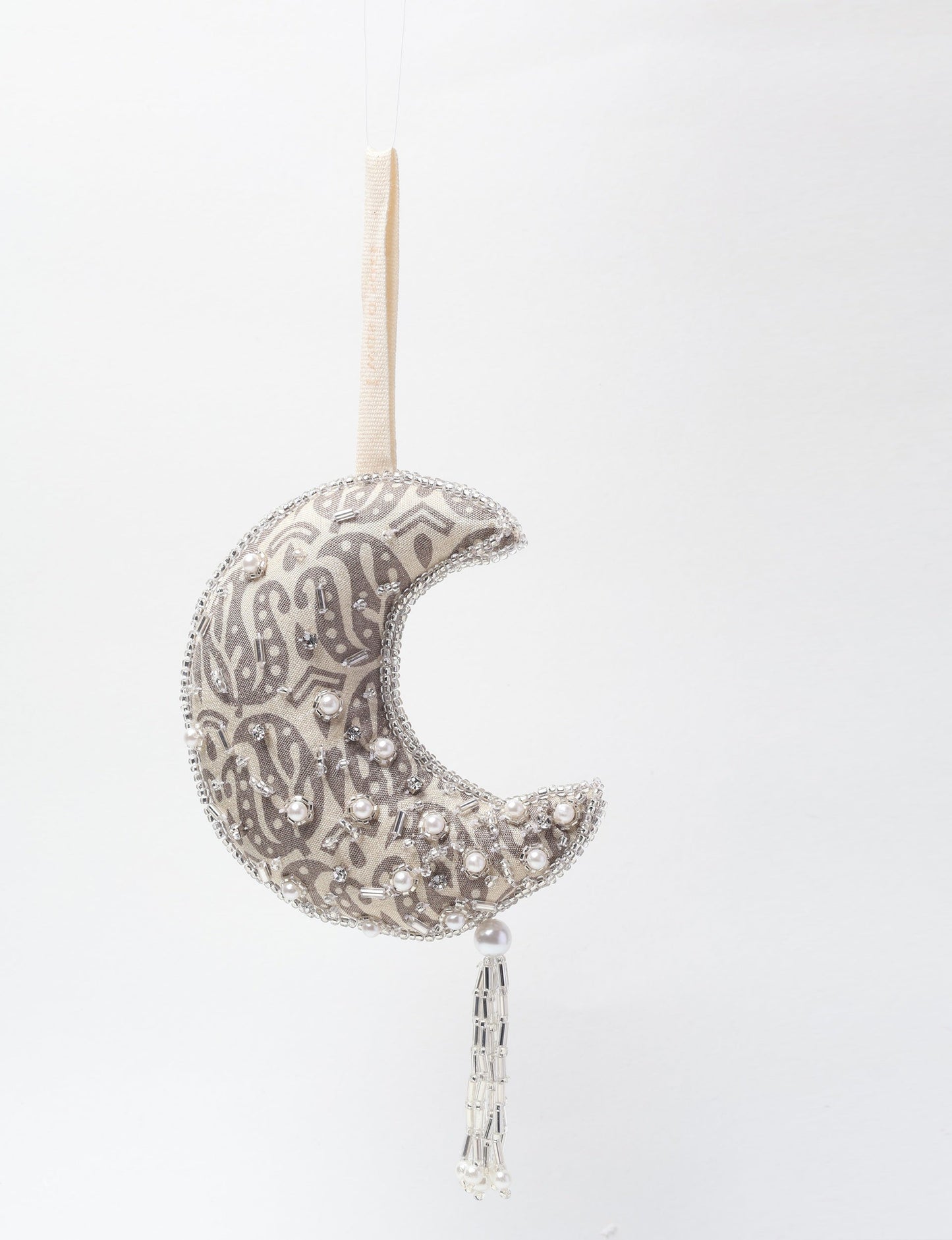 Crescent moon ornament made from recycled clothing, featuring fair trade fashion, clothes made from recycled fabric, and upcycled garments with elegant silver embellishments and tassel, ideal for those who value climate neutral clothing and recycled sustainable fashion.