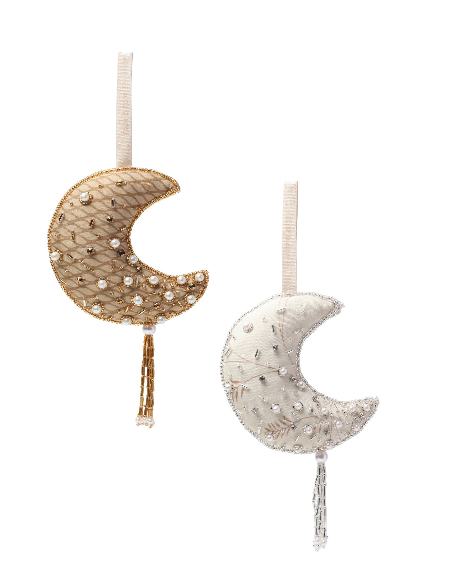 Set of two crescent moon-shaped Christmas ornaments handcrafted from upcycled saris, filled with organic cotton, and detailed with pearls, sequins, and tassels — a festive example of green fashion, upcycled clothing, and eco-friendly craftsmanship.