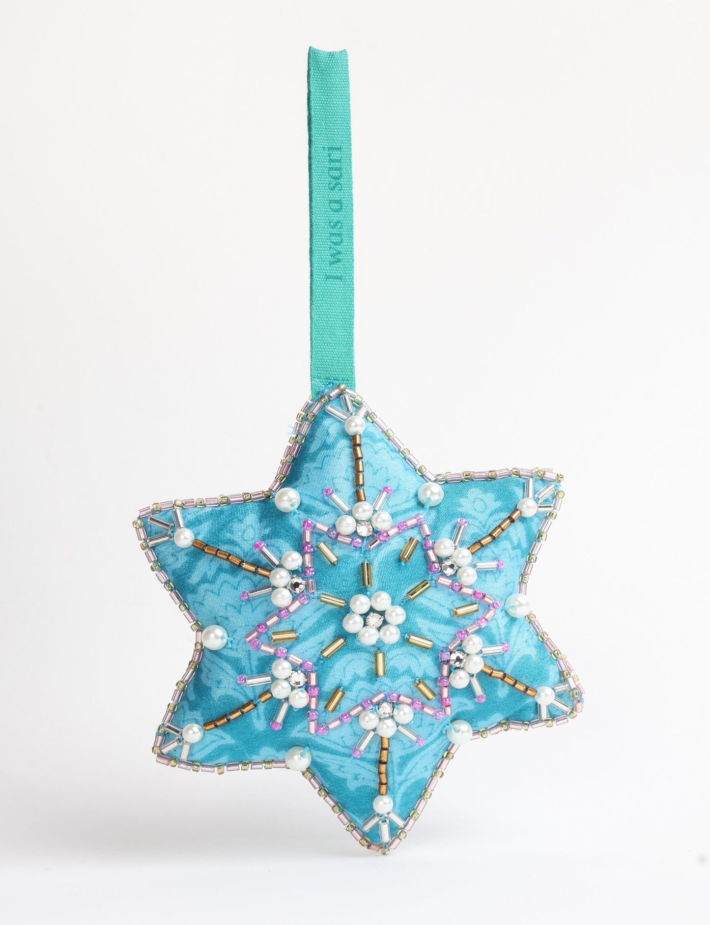 Upcycled snowflake Christmas ornament made from repurposed saris and hand-embroidered with Aari work using donated beads and stones — a conscious piece of eco clothing reflecting fair trade, green fashion, and sustainable women’s clothing ideals.