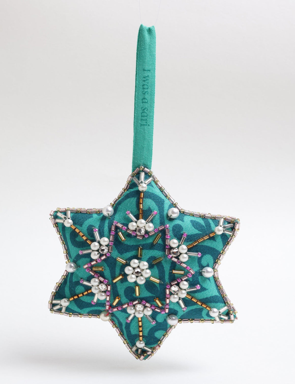 Teal fabric star-shaped snowflake ornament with bead and pearl embellishments, hanging by a teal fabric loop