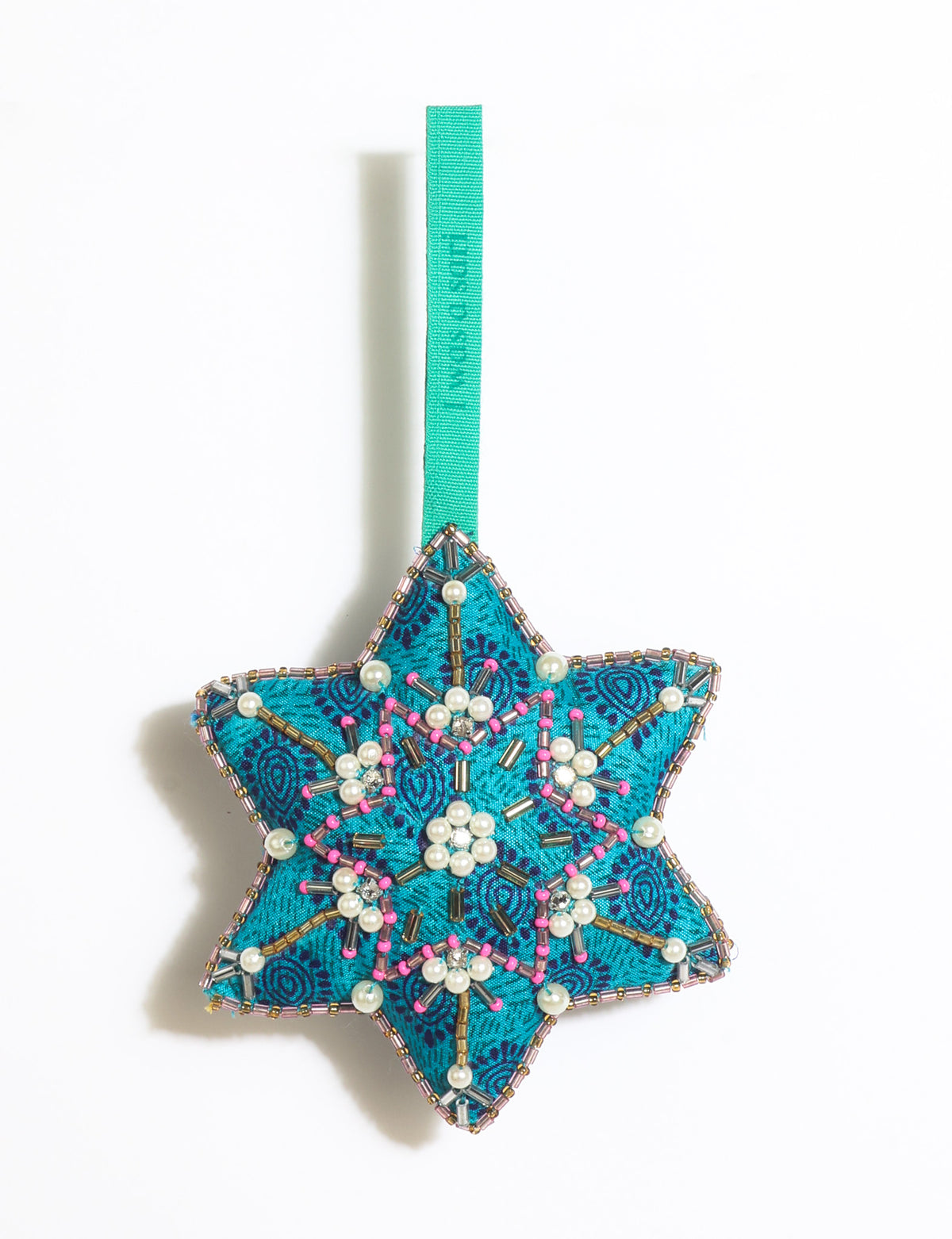Teal fabric star-shaped snowflake ornament with bead and pearl embellishments, hanging by a teal fabric loop