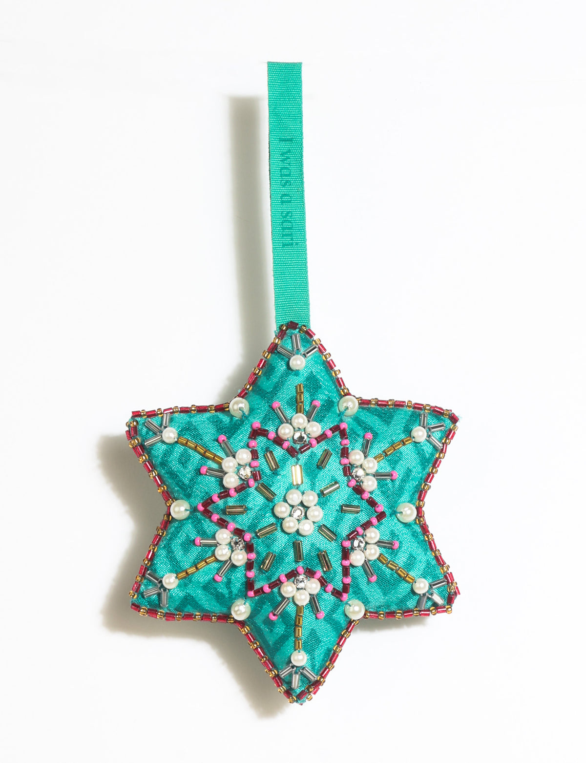 Teal fabric star-shaped snowflake ornament with bead and pearl embellishments, hanging by a teal fabric loop
