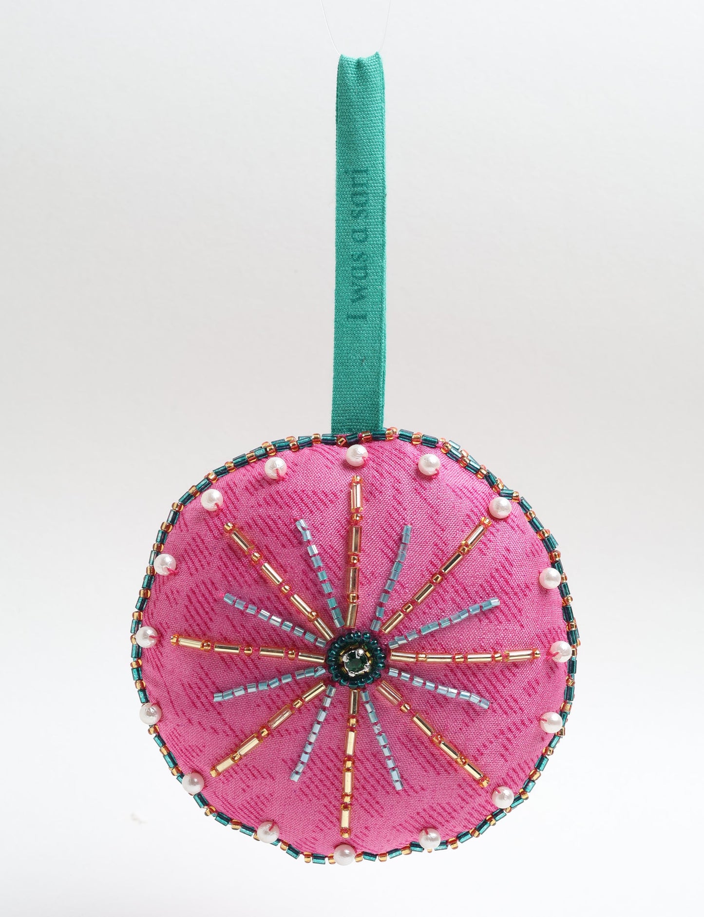 Handcrafted full moon ornament made from recycled sari fabric and embroidered with beads — an example of upcycled clothing and slow fashion, promoting eco clothing, recycled fashion, and conscious clothing practices.