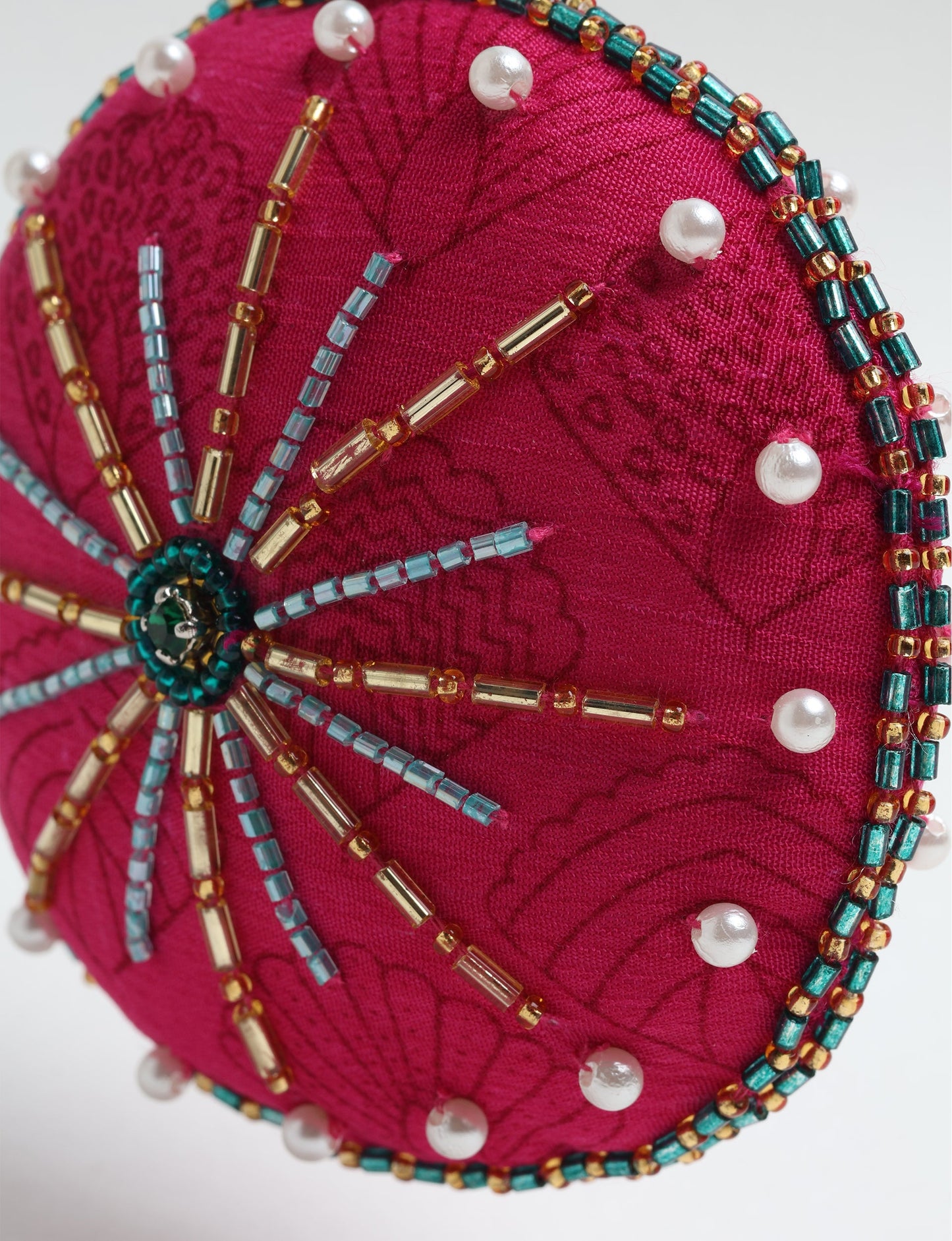Handcrafted full moon ornament made from recycled sari fabric and embroidered with beads — an example of upcycled clothing and slow fashion, promoting eco clothing, recycled fashion, and conscious clothing practices.
