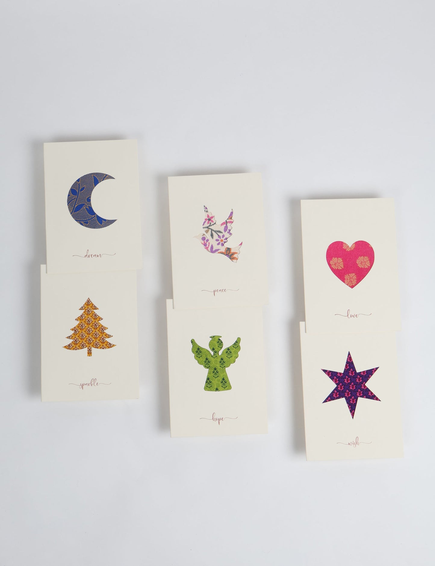 Folded greeting card set of 6 made from recycled sari scraps, symbolising Wish, Hope, Sparkle, Love, Peace, and Dream — beautifully designed with repurposed clothing textiles, upcycled garments, circular fashion inspiration, and fair trade fashion aesthetics, reflecting environmentally friendly clothing values.