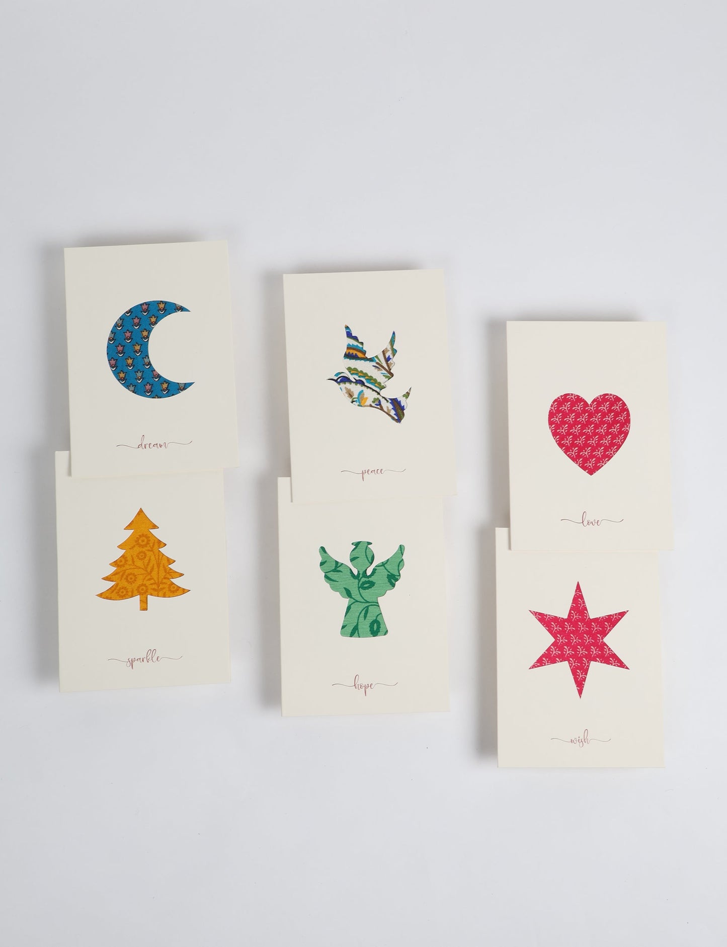Folded greeting card set of 6 made from recycled sari scraps, symbolising Wish, Hope, Sparkle, Love, Peace, and Dream — beautifully designed with repurposed clothing textiles, upcycled garments, circular fashion inspiration, and fair trade fashion aesthetics, reflecting environmentally friendly clothing values.
