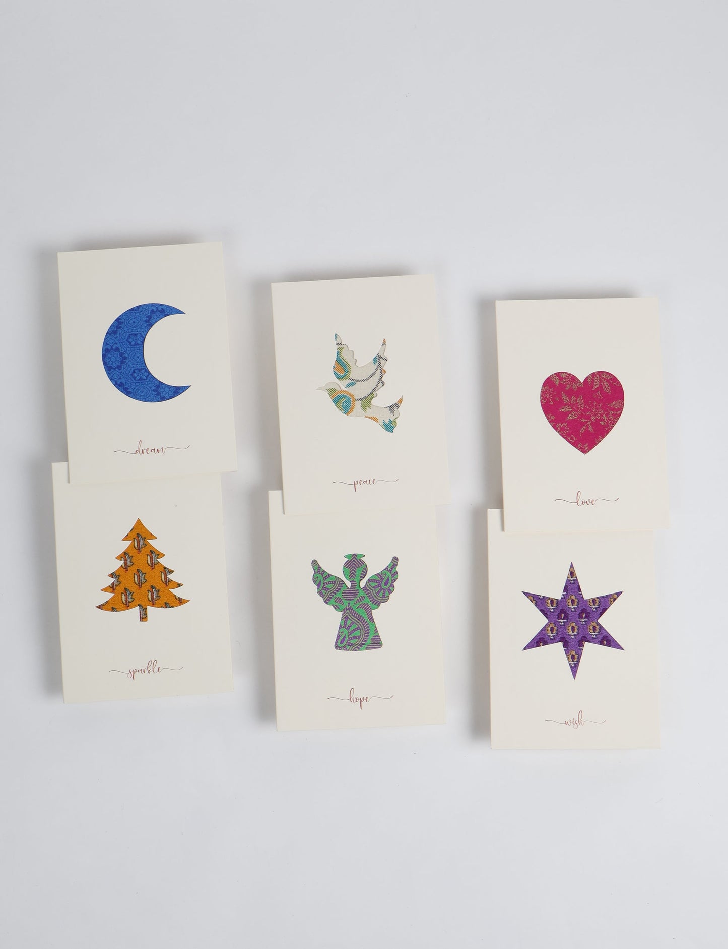 Folded greeting card set of 6 made from recycled sari scraps, symbolising Wish, Hope, Sparkle, Love, Peace, and Dream — beautifully designed with repurposed clothing textiles, upcycled garments, circular fashion inspiration, and fair trade fashion aesthetics, reflecting environmentally friendly clothing values.