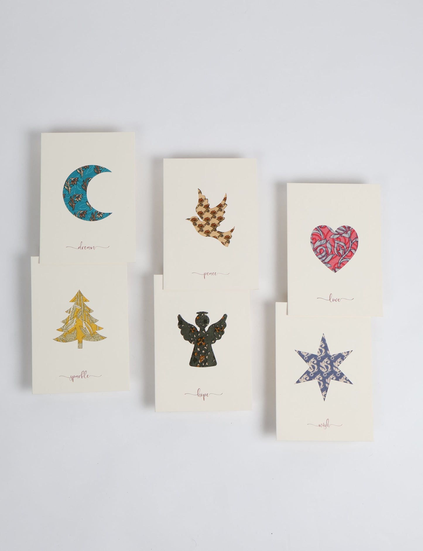 Folded greeting card set of 6 made from recycled sari scraps, symbolising Wish, Hope, Sparkle, Love, Peace, and Dream — beautifully designed with repurposed clothing textiles, upcycled garments, circular fashion inspiration, and fair trade fashion aesthetics, reflecting environmentally friendly clothing values.