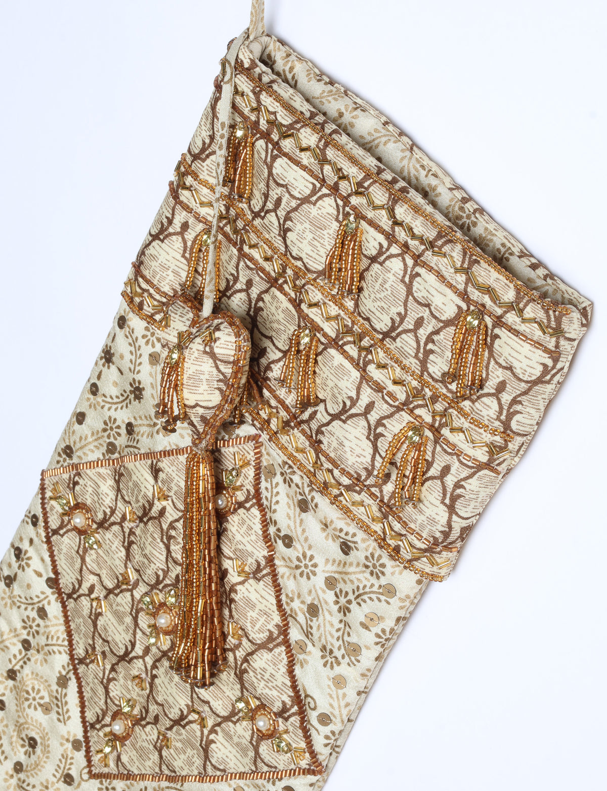 Ivory and cream upcycled sari Christmas stocking with gold hand embroidery, patchwork detailing, and a beaded heart charm tassel — crafted from recycled materials and inspired by circular, fair trade, and eco clothing fashion.