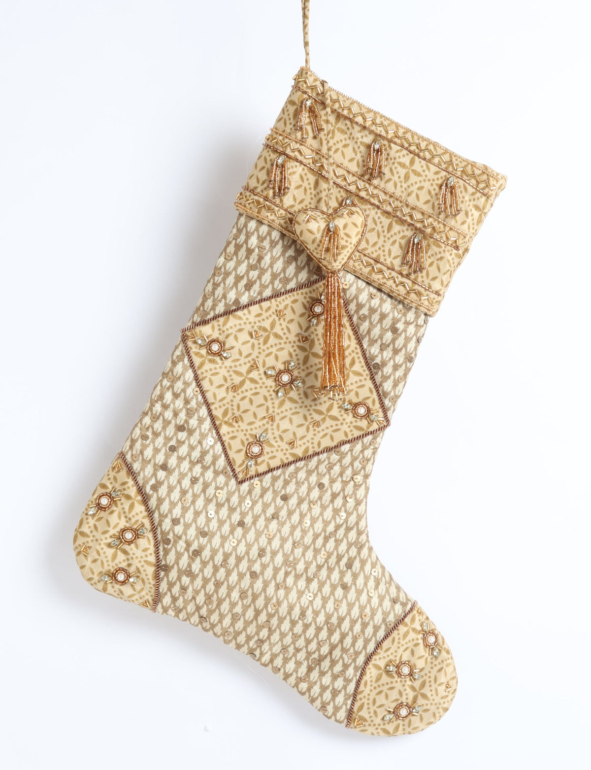 Beige patchwork Christmas stocking with micro floral design, bead tassels, and sequin embellishments, hanging flat against white background