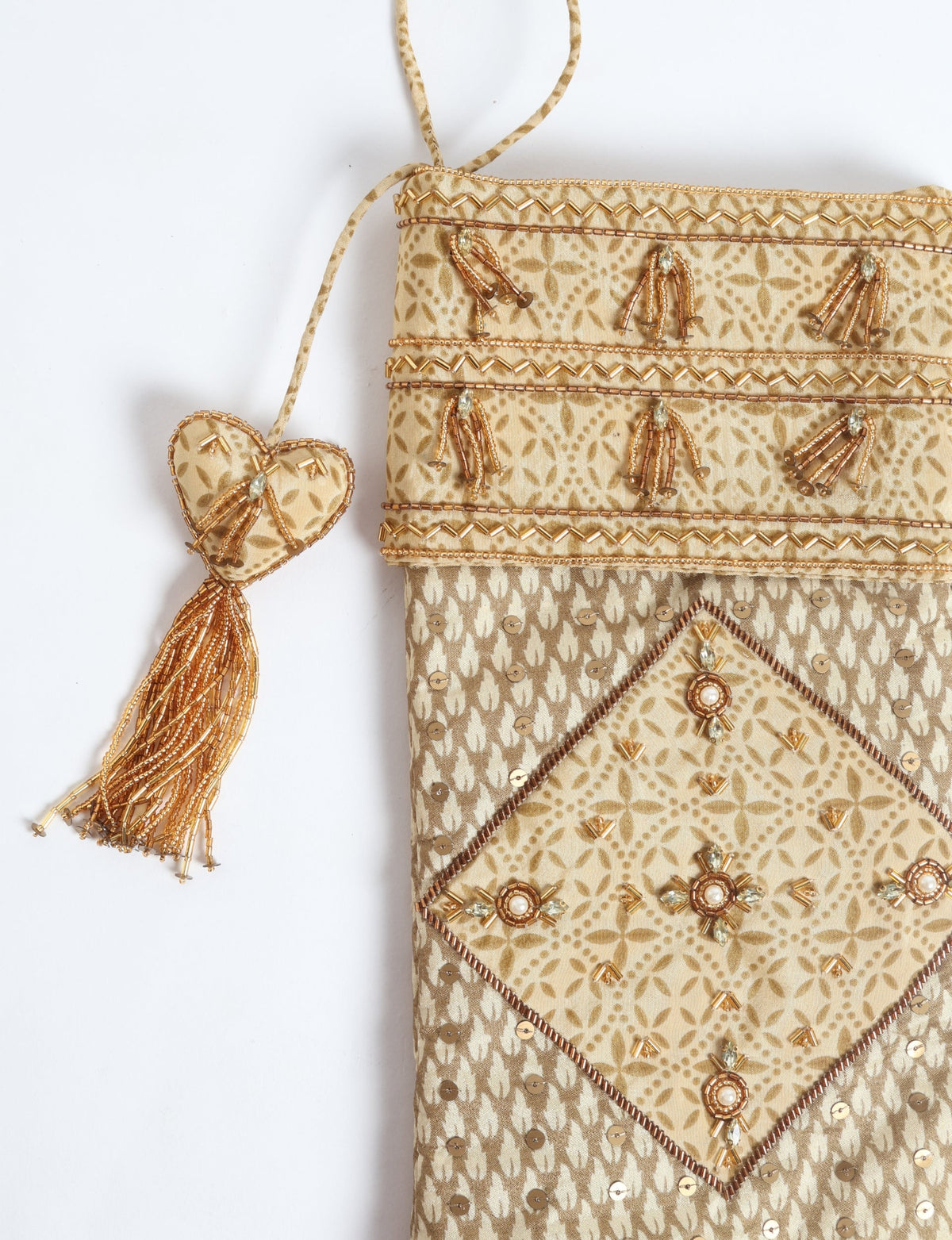 Beige patchwork Christmas stocking with micro floral pattern, gold bead and sequin embellishments, and heart-shaped tassel detail