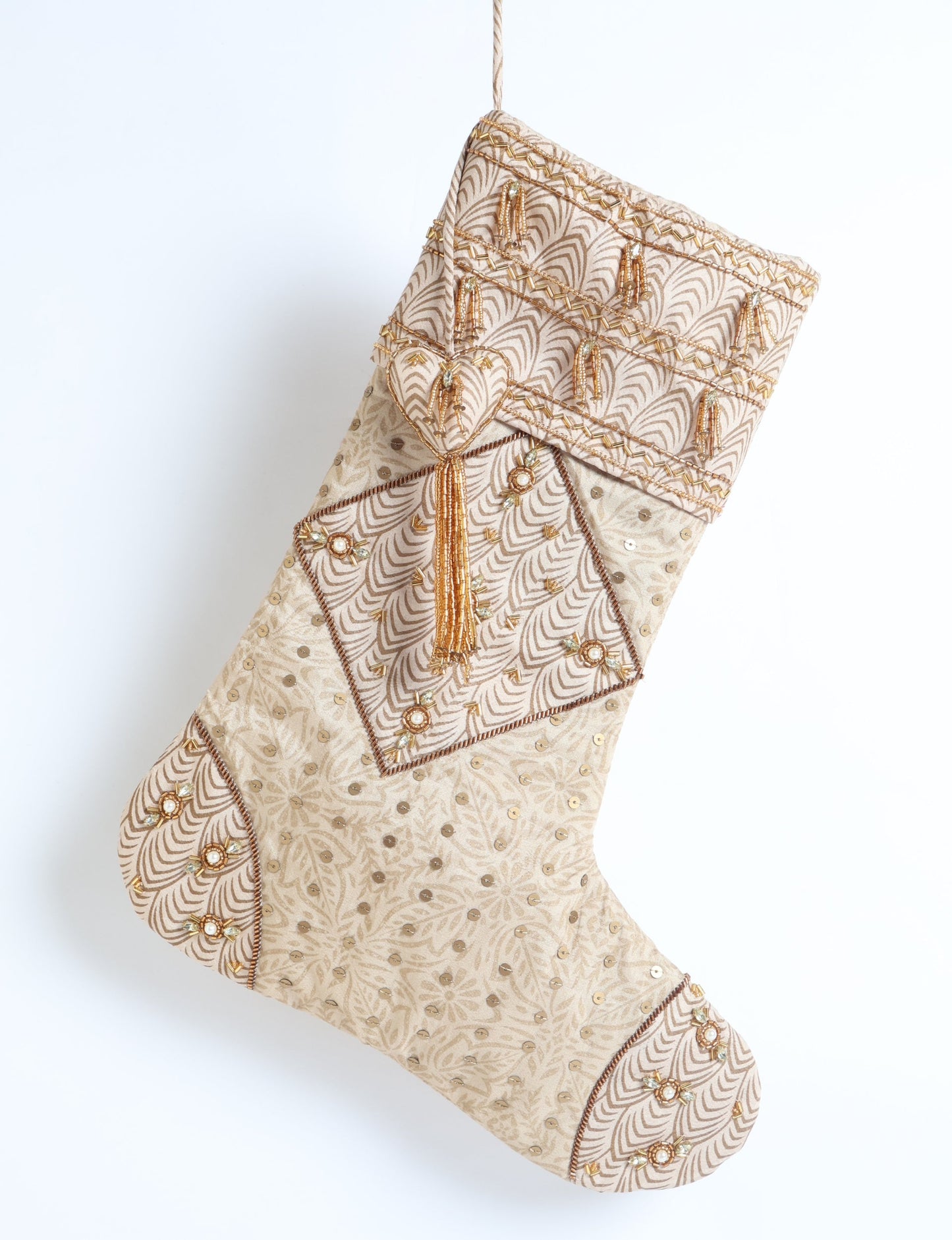 Ivory and cream upcycled sari Christmas stocking with gold hand embroidery, patchwork detailing, and a beaded heart charm tassel — crafted from recycled materials and inspired by circular, fair trade, and eco clothing fashion.