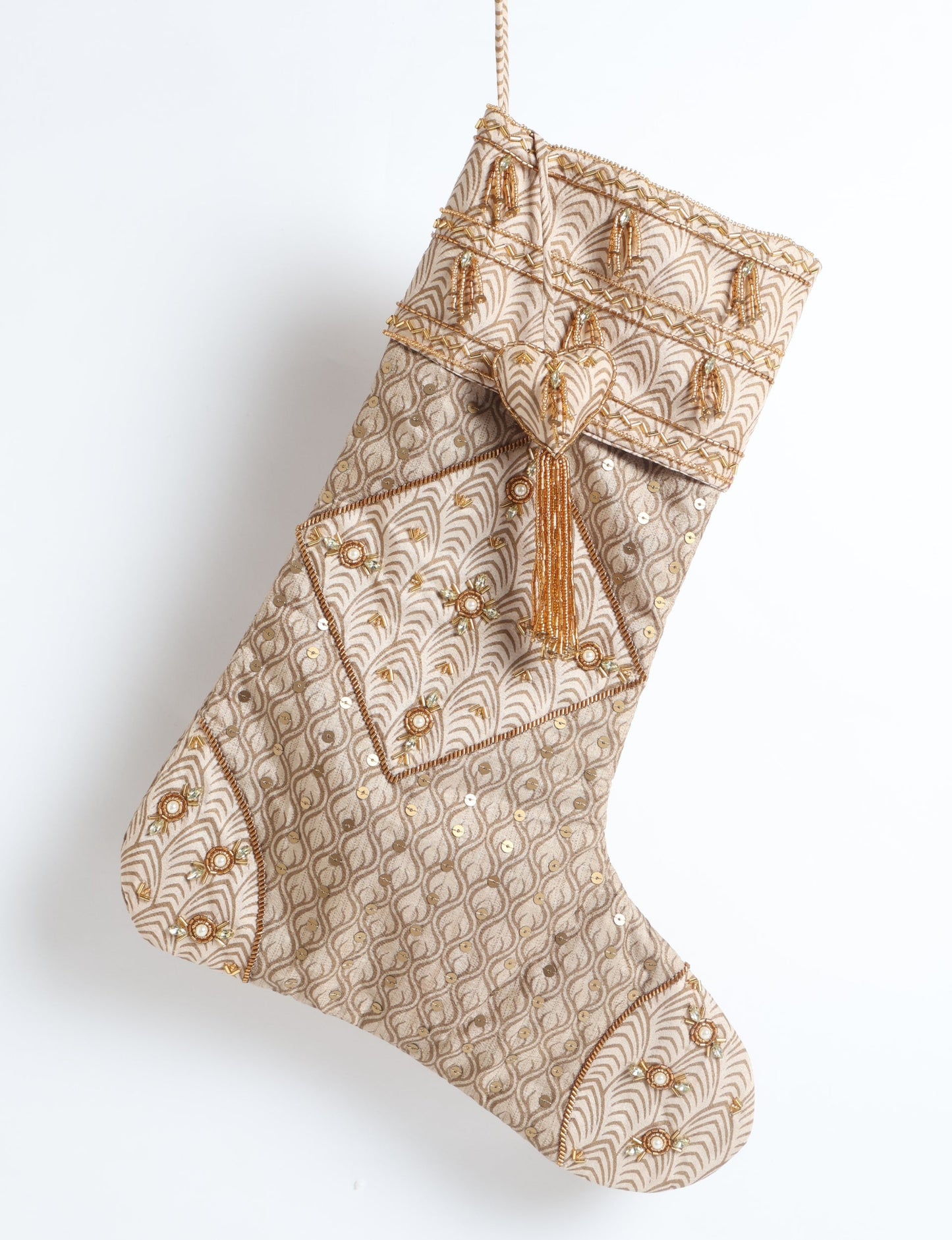 Ivory and cream upcycled sari Christmas stocking with gold hand embroidery, patchwork detailing, and a beaded heart charm tassel — crafted from recycled materials and inspired by circular, fair trade, and eco clothing fashion.