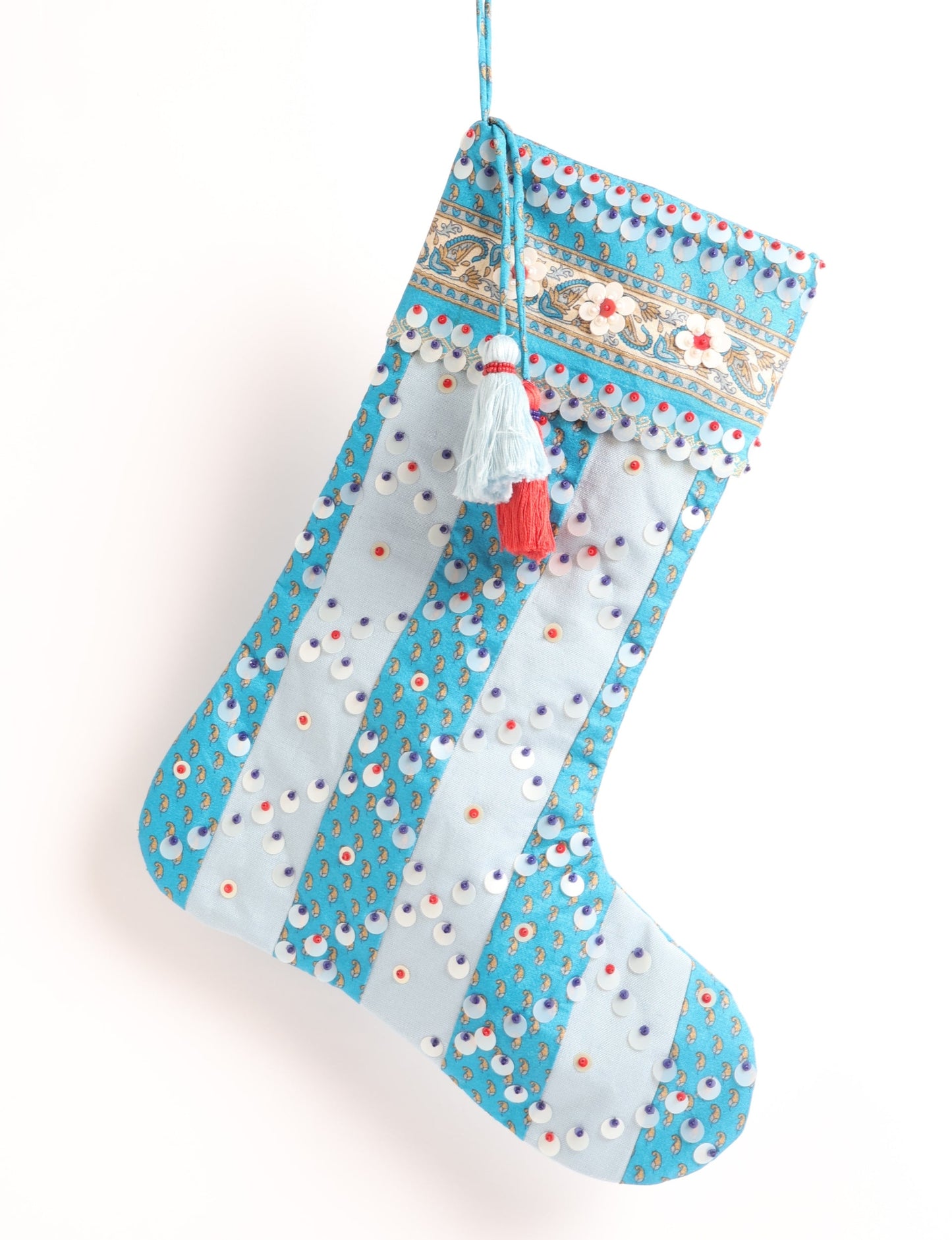 Upcycled sari Christmas stocking with striped cotton accents and hand-embroidered embellishments, reflecting green fashion, zero-waste clothing, recycled fashion, repurposed clothing, carbon-neutral fashion, natural clothing, conscious clothing, and sustainable women’s clothing.