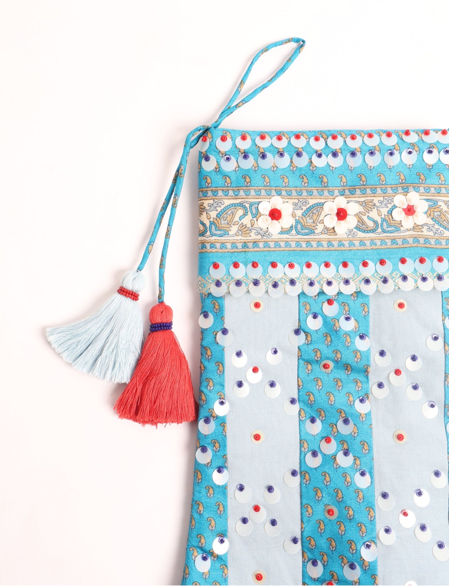 Upcycled sari Christmas stocking with striped cotton accents and hand-embroidered embellishments, reflecting green fashion, zero-waste clothing, recycled fashion, repurposed clothing, carbon-neutral fashion, natural clothing, conscious clothing, and sustainable women’s clothing.