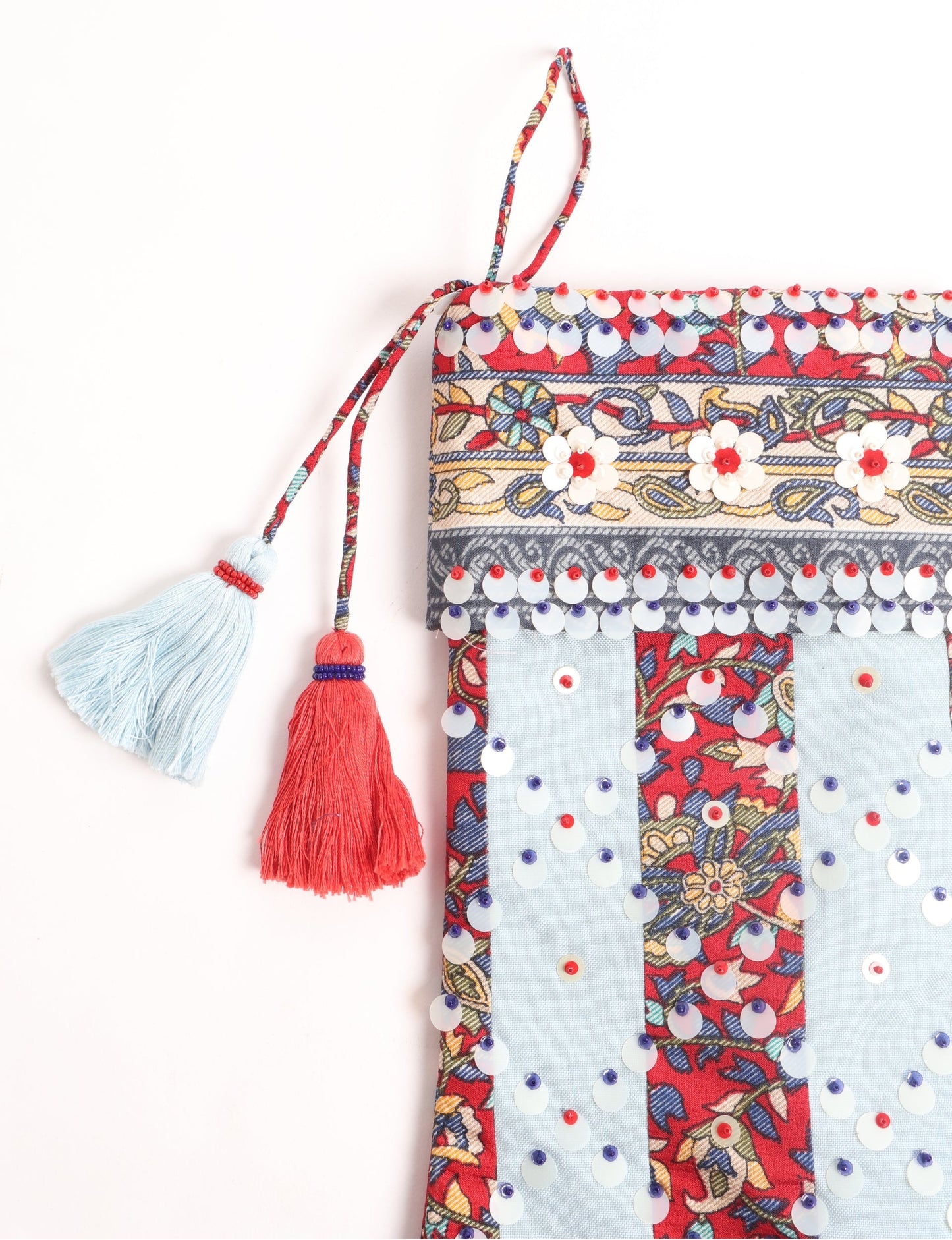 Upcycled sari Christmas stocking with striped cotton accents and hand-embroidered embellishments, reflecting green fashion, zero-waste clothing, recycled fashion, repurposed clothing, carbon-neutral fashion, natural clothing, conscious clothing, and sustainable women’s clothing.