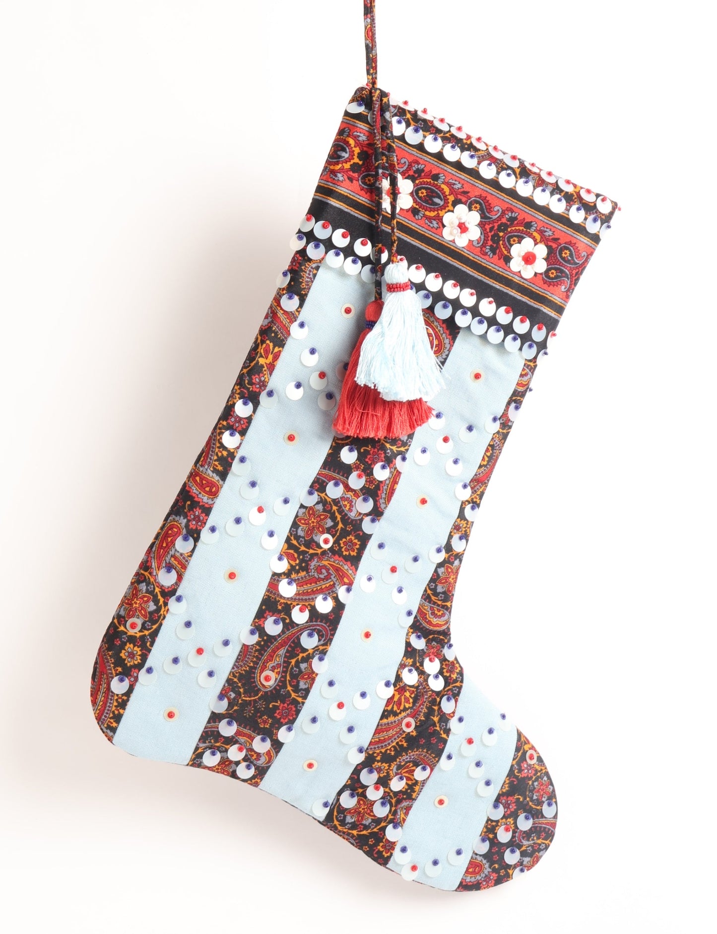 Upcycled sari Christmas stocking with striped cotton accents and hand-embroidered embellishments, reflecting green fashion, zero-waste clothing, recycled fashion, repurposed clothing, carbon-neutral fashion, natural clothing, conscious clothing, and sustainable women’s clothing.