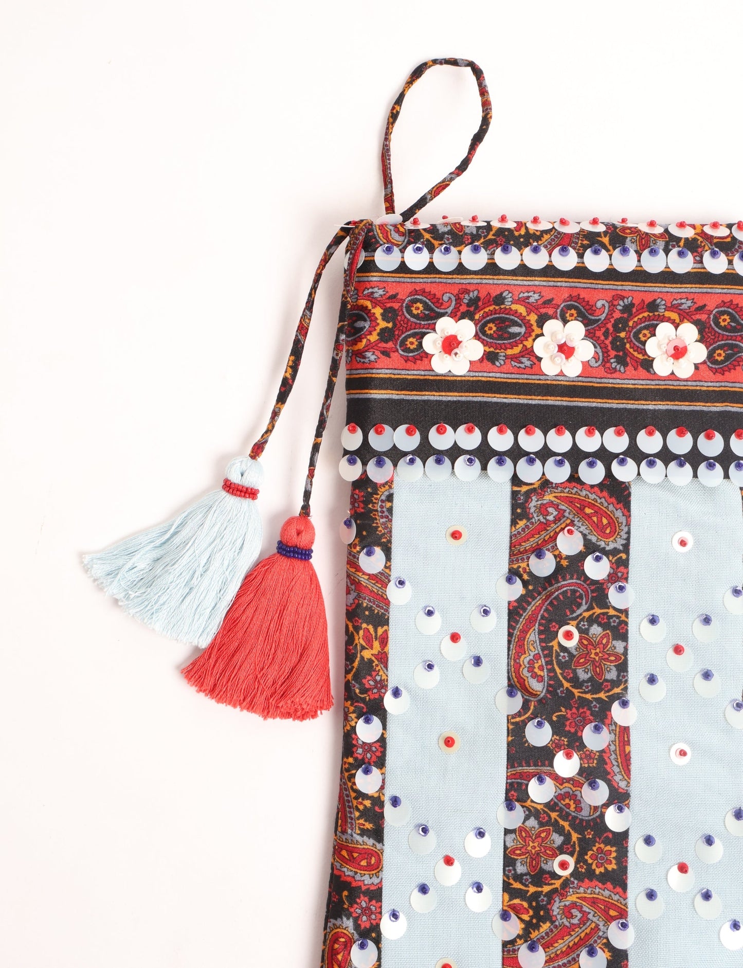 Upcycled sari Christmas stocking with striped cotton accents and hand-embroidered embellishments, reflecting green fashion, zero-waste clothing, recycled fashion, repurposed clothing, carbon-neutral fashion, natural clothing, conscious clothing, and sustainable women’s clothing.