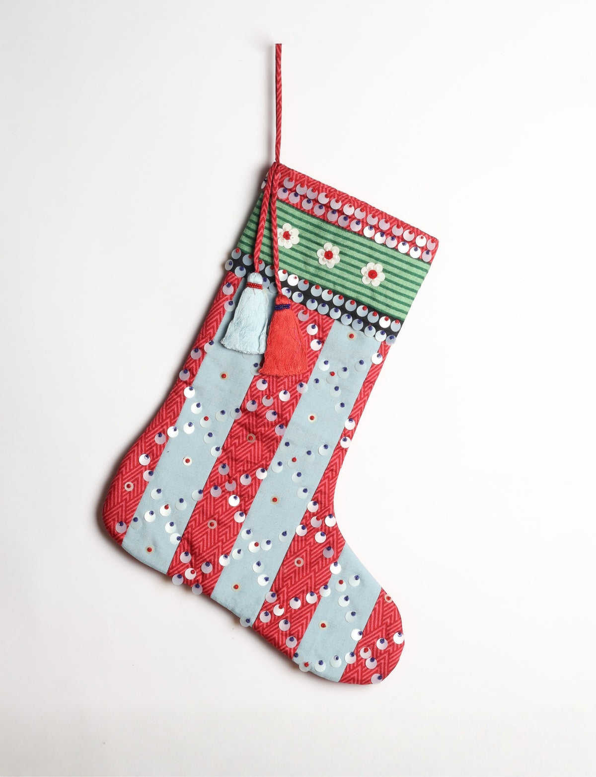 Upcycled sari Christmas stocking with striped cotton accents and hand-embroidered embellishments, reflecting green fashion, zero-waste clothing, recycled fashion, repurposed clothing, carbon-neutral fashion, natural clothing, conscious clothing, and sustainable women’s clothing.