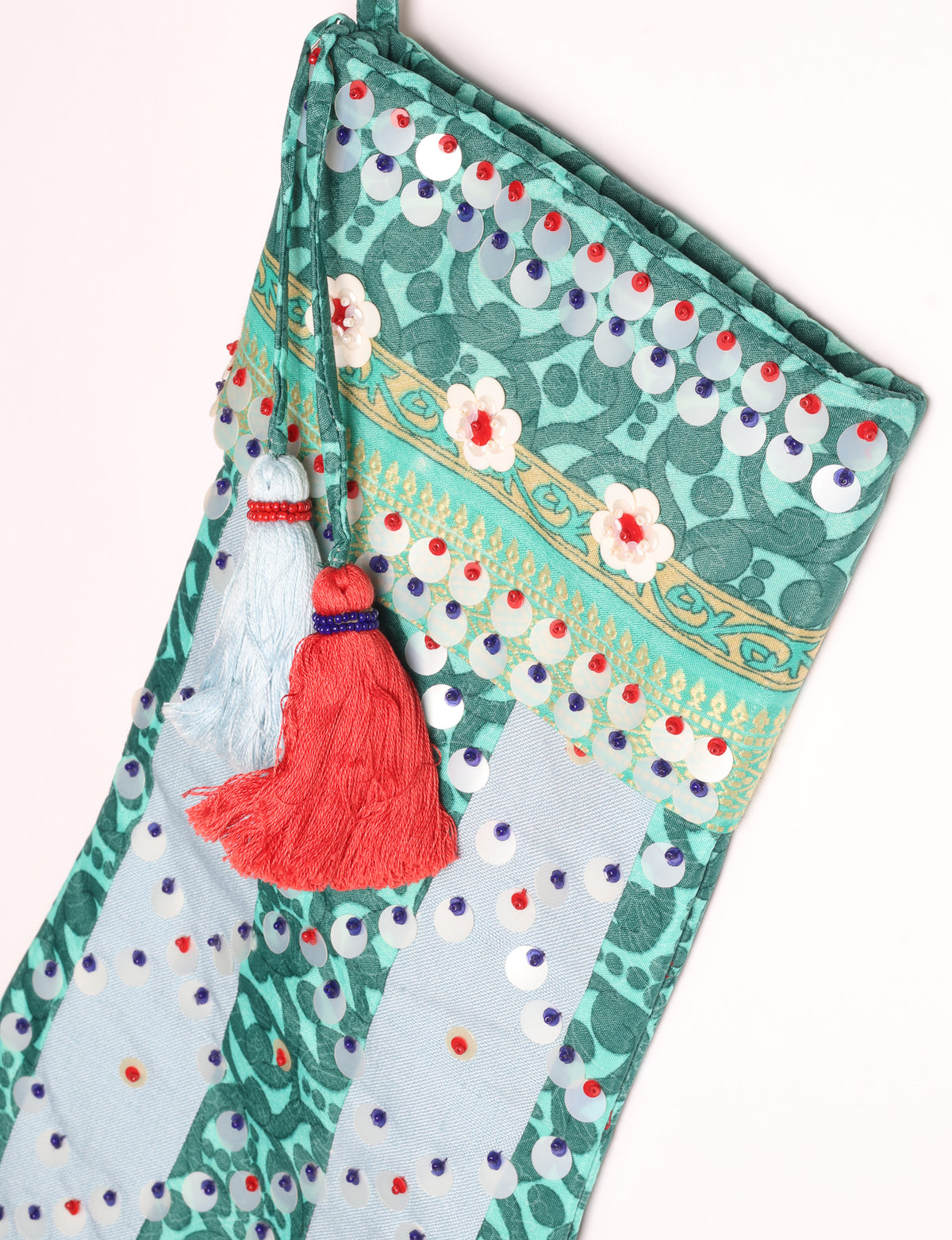 Upcycled sari Christmas stocking with striped cotton accents and hand-embroidered embellishments, reflecting green fashion, zero-waste clothing, recycled fashion, repurposed clothing, carbon-neutral fashion, natural clothing, conscious clothing, and sustainable women’s clothing.