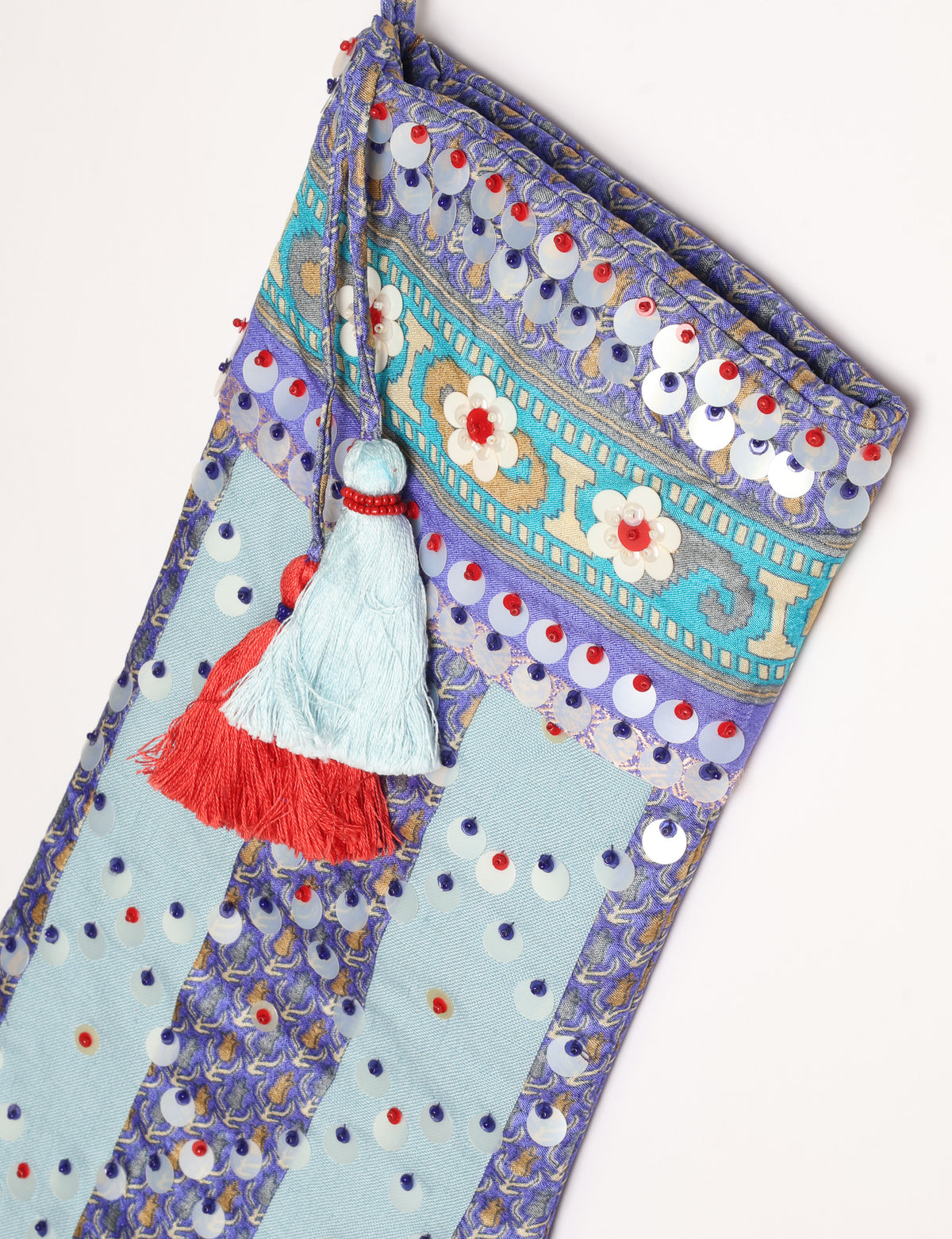 Upcycled sari Christmas stocking with striped cotton accents and hand-embroidered embellishments, reflecting green fashion, zero-waste clothing, recycled fashion, repurposed clothing, carbon-neutral fashion, natural clothing, conscious clothing, and sustainable women’s clothing.