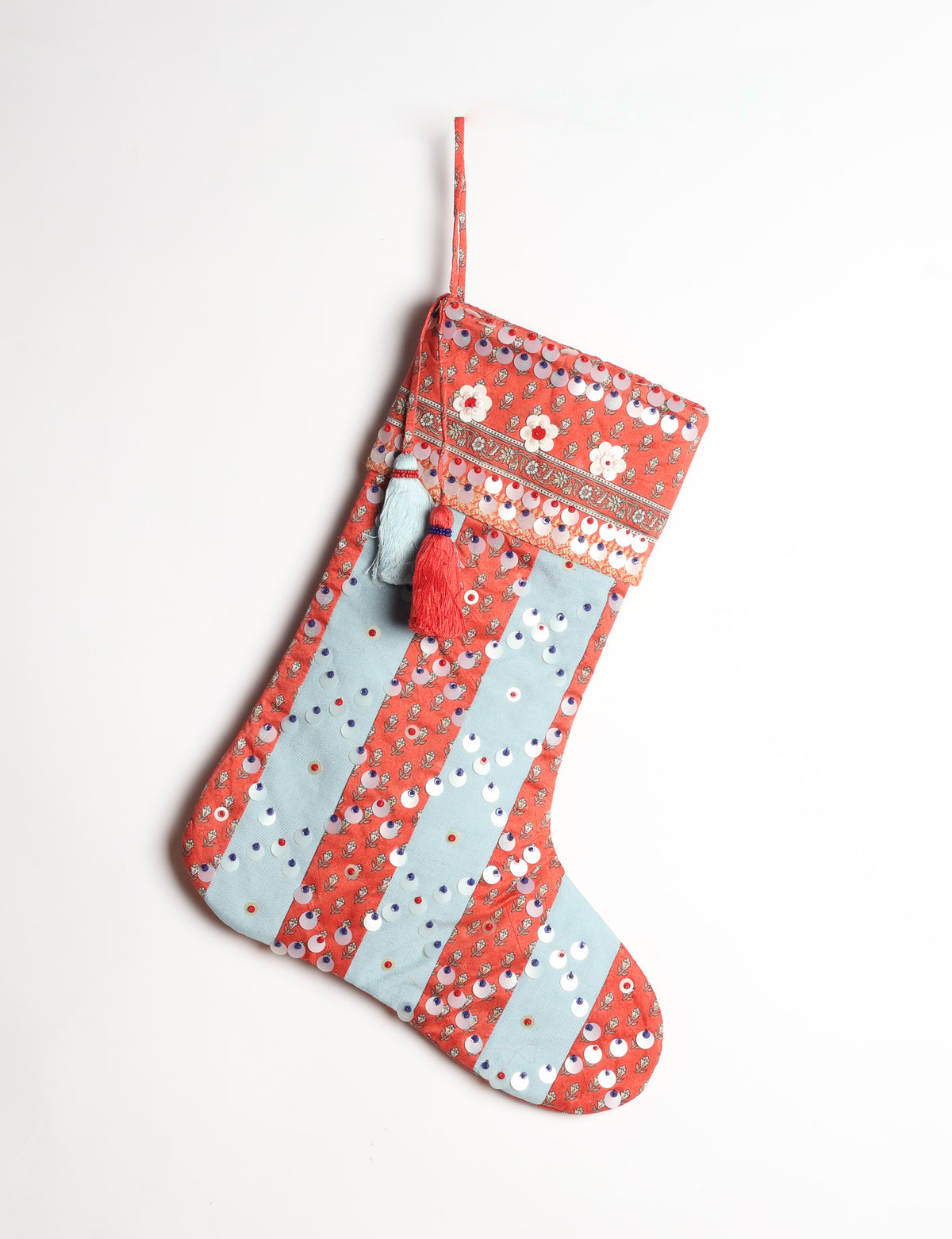 Upcycled sari Christmas stocking with striped cotton accents and hand-embroidered embellishments, reflecting green fashion, zero-waste clothing, recycled fashion, repurposed clothing, carbon-neutral fashion, natural clothing, conscious clothing, and sustainable women’s clothing.