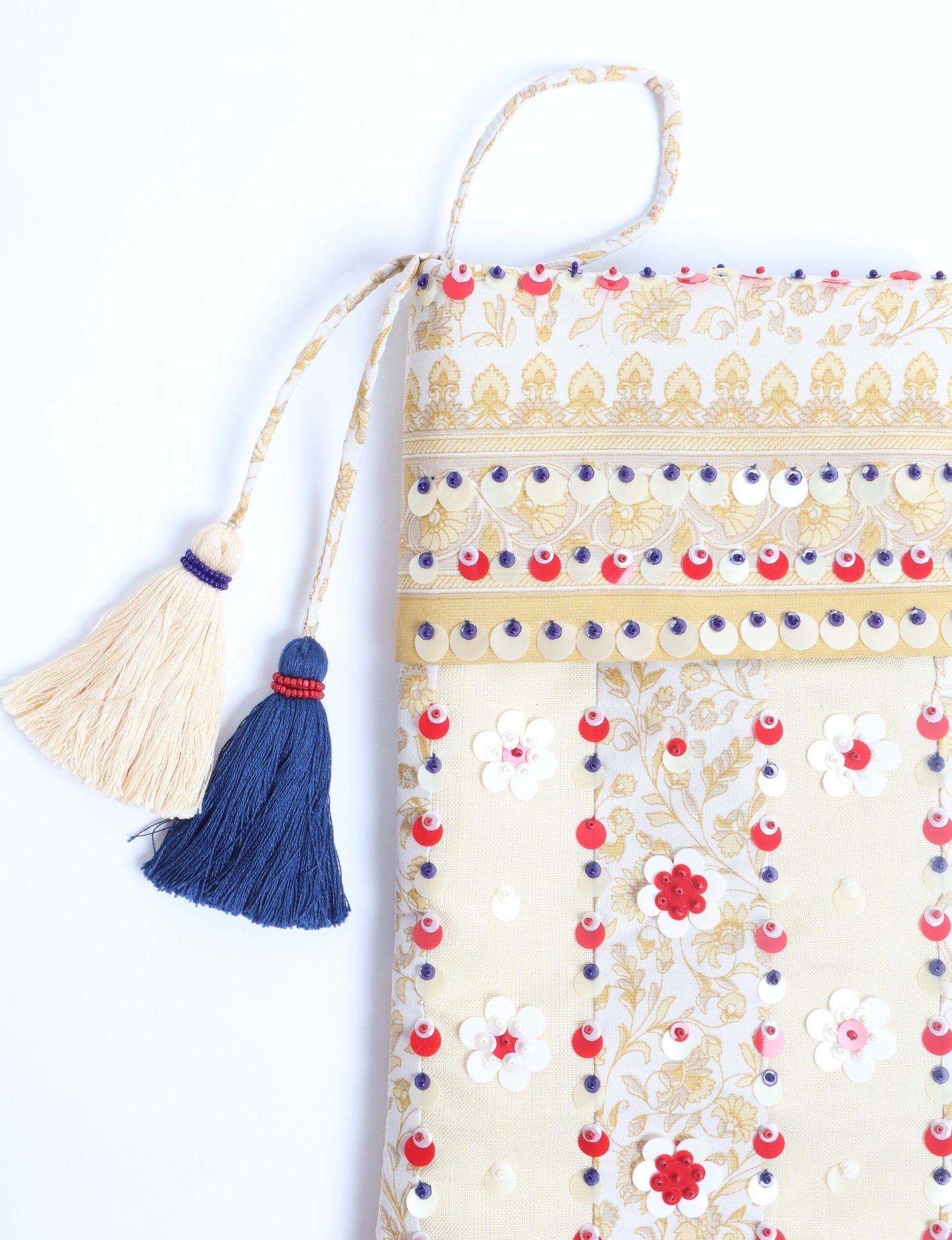 Upcycled sari Christmas stocking with floral beadwork, showcasing ethical fashion, recycled material clothing, fair trade fashion craftsmanship, and environment friendly clothing design.