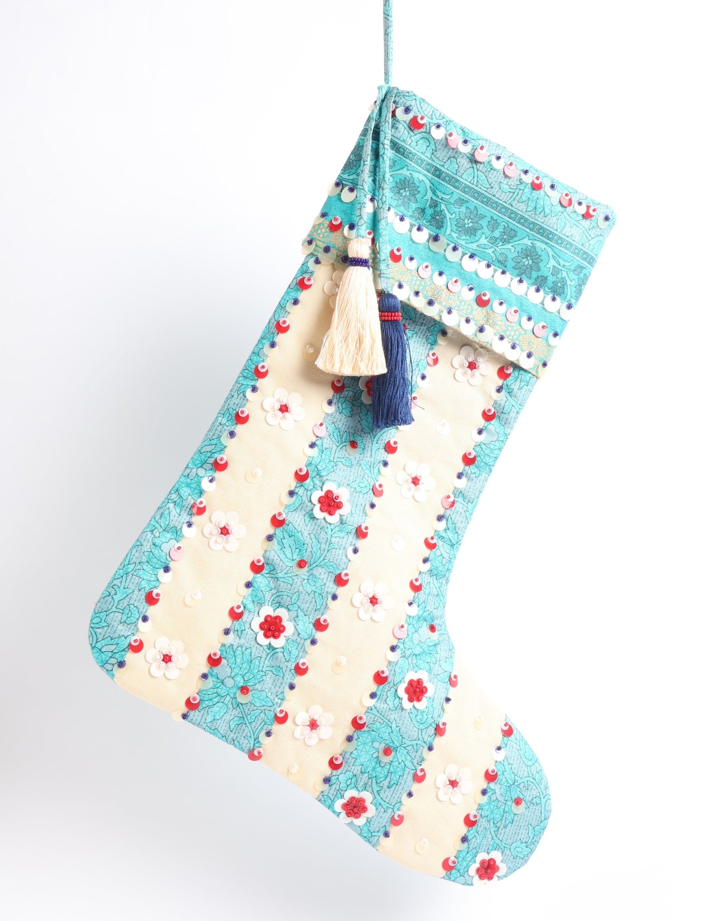 Upcycled sari Christmas stocking with floral beadwork, showcasing ethical fashion, recycled material clothing, fair trade fashion craftsmanship, and environment friendly clothing design.